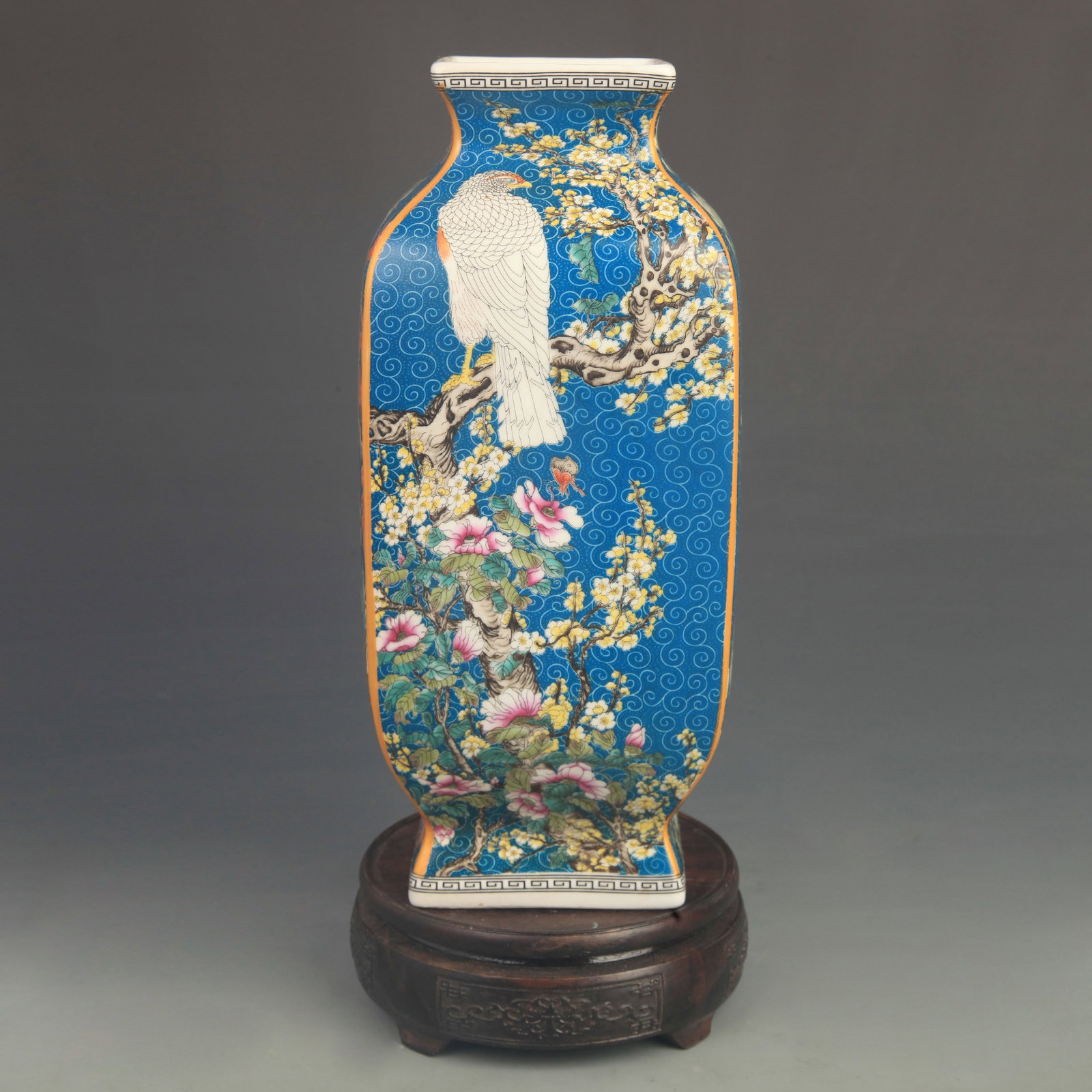 FAMILLE ROSE BLUE GROUND FLOWER AND BIRD FOUR-SIDED VASE: Qing Dynasty Qian Long Period; High: 11.0 inch; Diameter: 4.80 inch; Wooden base for diplay only