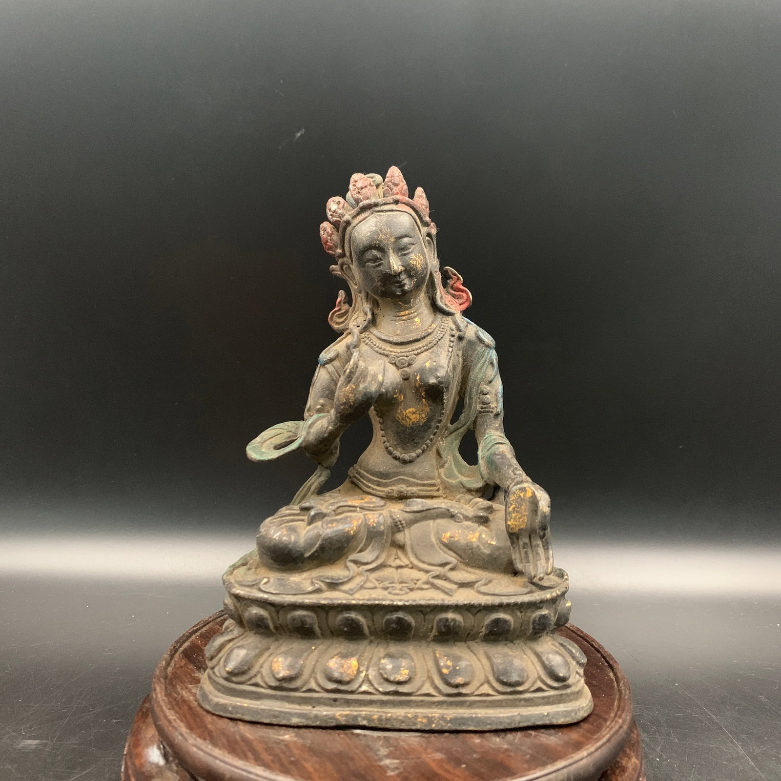 A SINO-TIBETAN PARCEL-GILT BRONZE FIGURE OF GREEN TARA