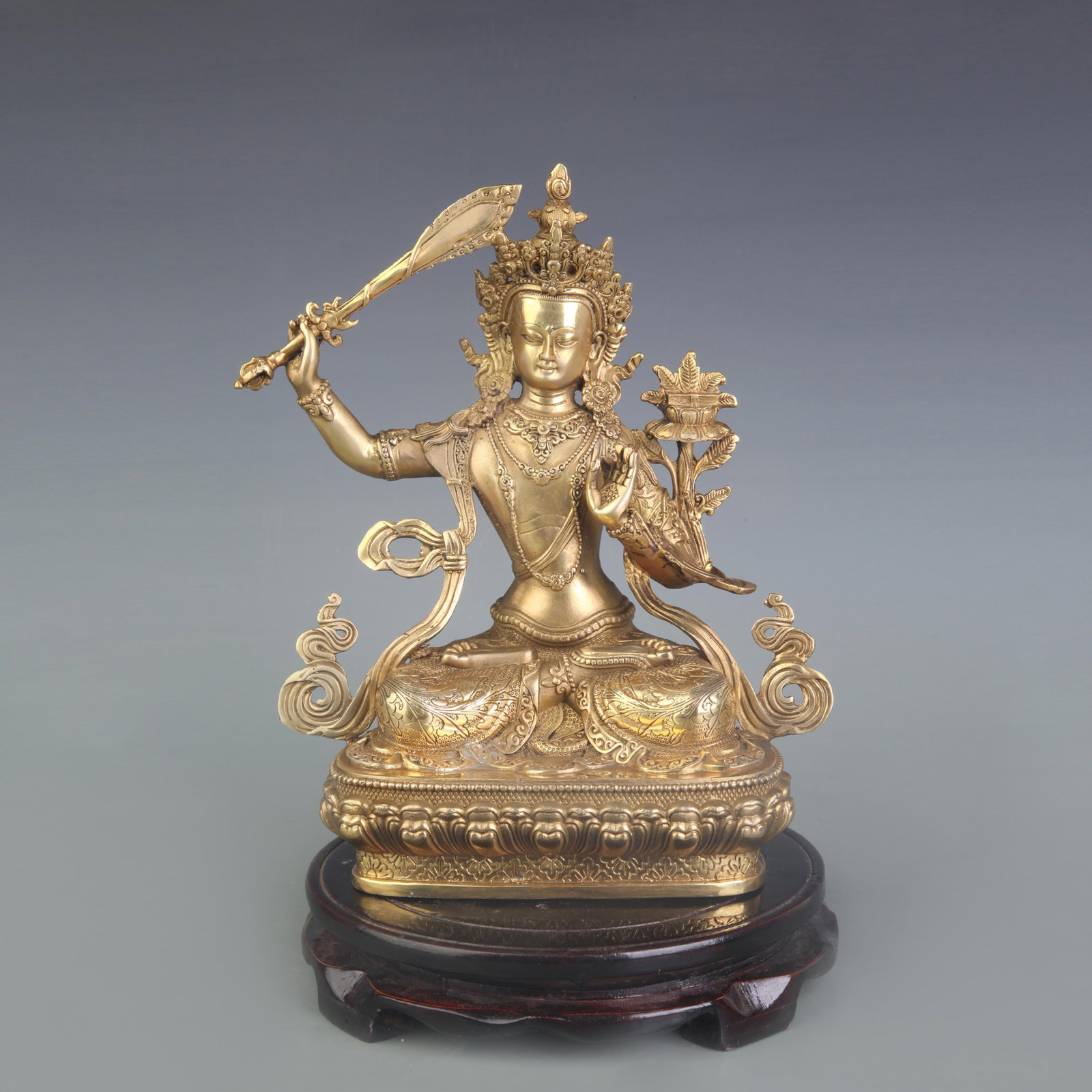 A FINE BRONZE STATUE OF MANJUSHRI BODHISATTVA: Qing Dynasty; High: 9.0 inch; Wooden base for diplay only