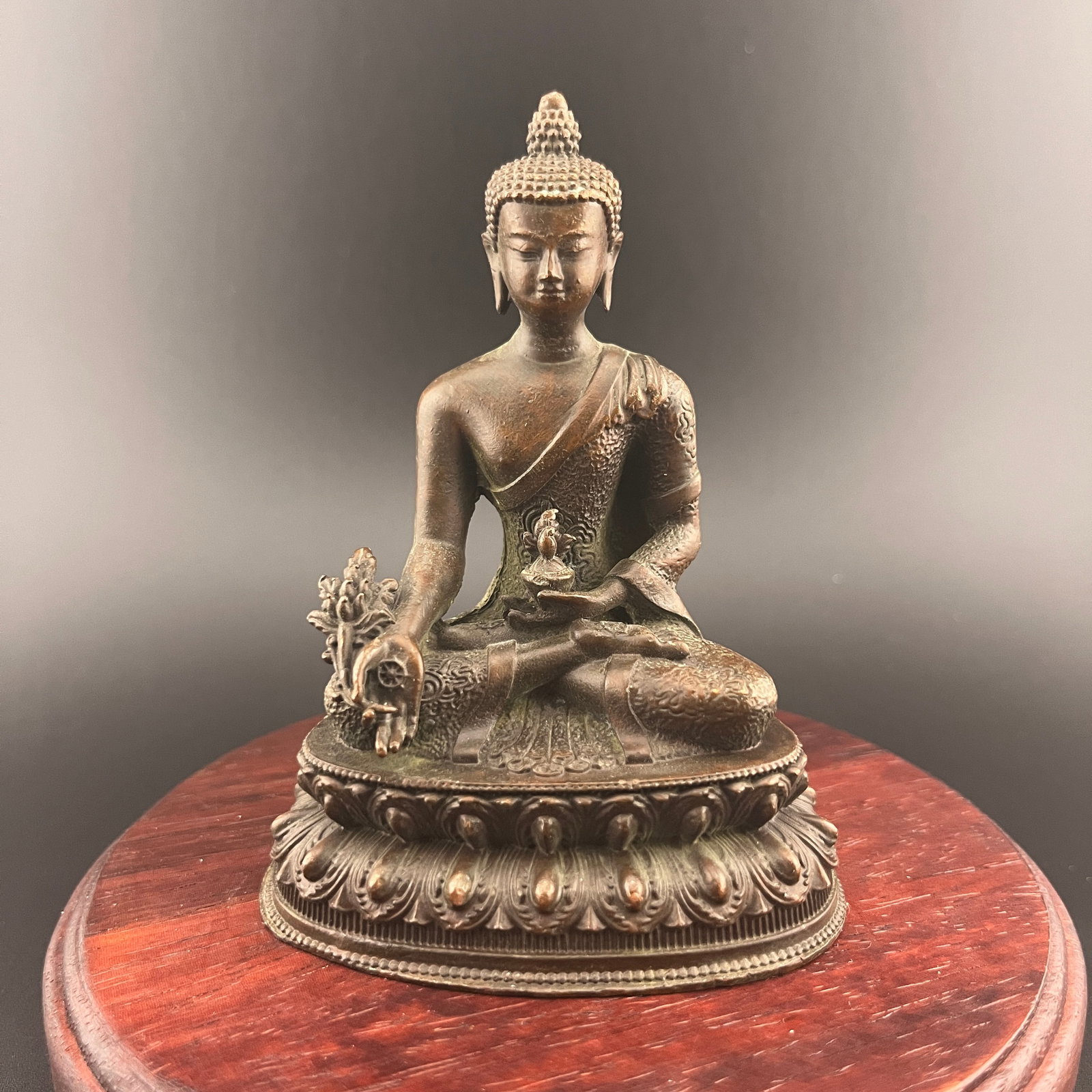 A SMALL BRONZE STATUE OF SHAKAMUNI BUDDHA: 19th Century; Long: 2.94 inch; Width: 2.1 inch; High: 3.9 inch; Wooden base for diplay only