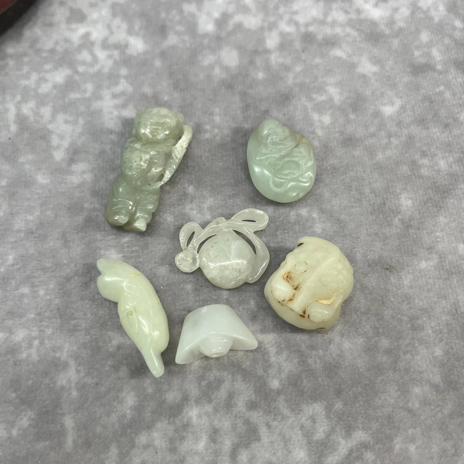 GROUP OF SIX HAND CARVED HETIAN JADE PENDANT
