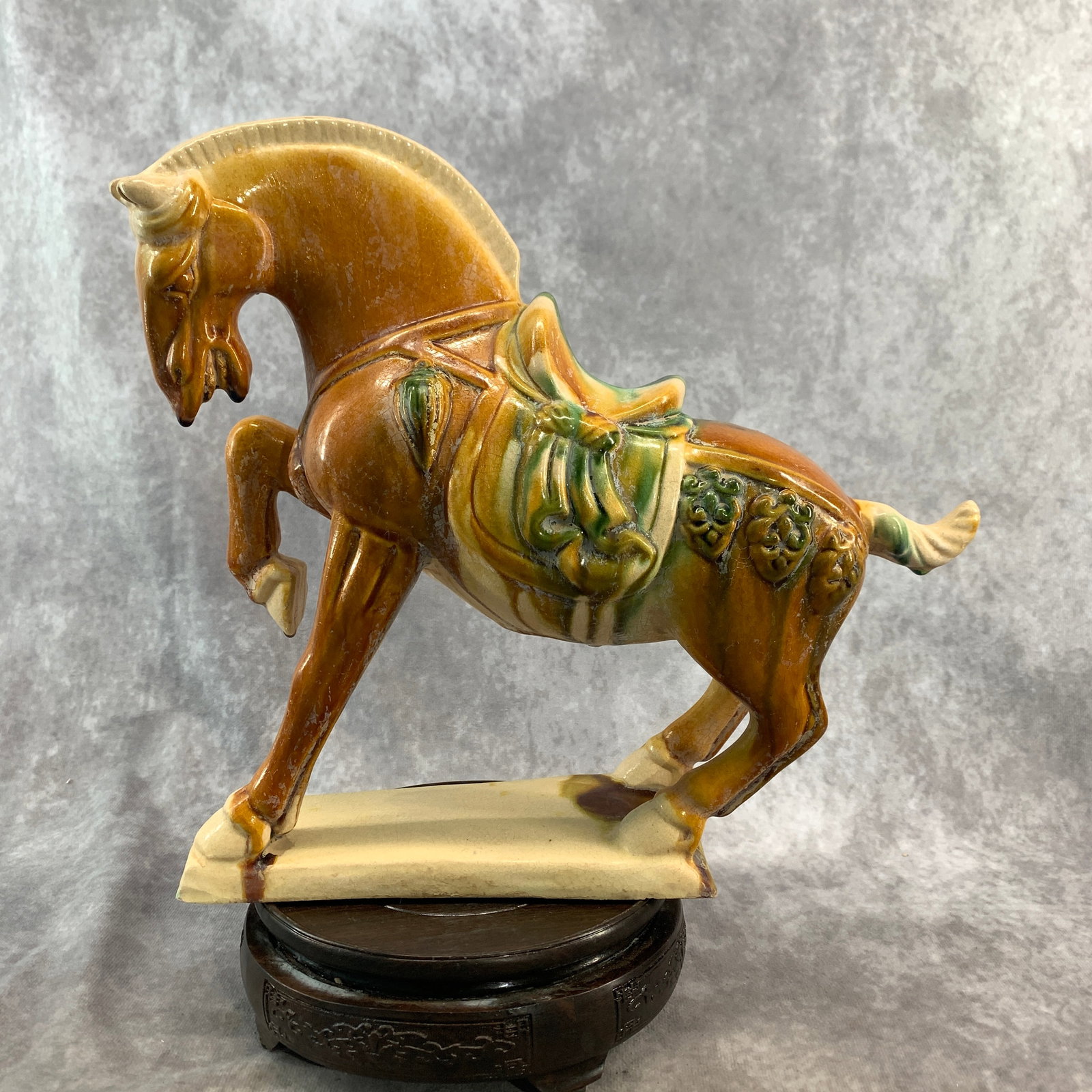 A SANCAI-GLAZED POTTERY FIGURE OF A PRANCING HORSE