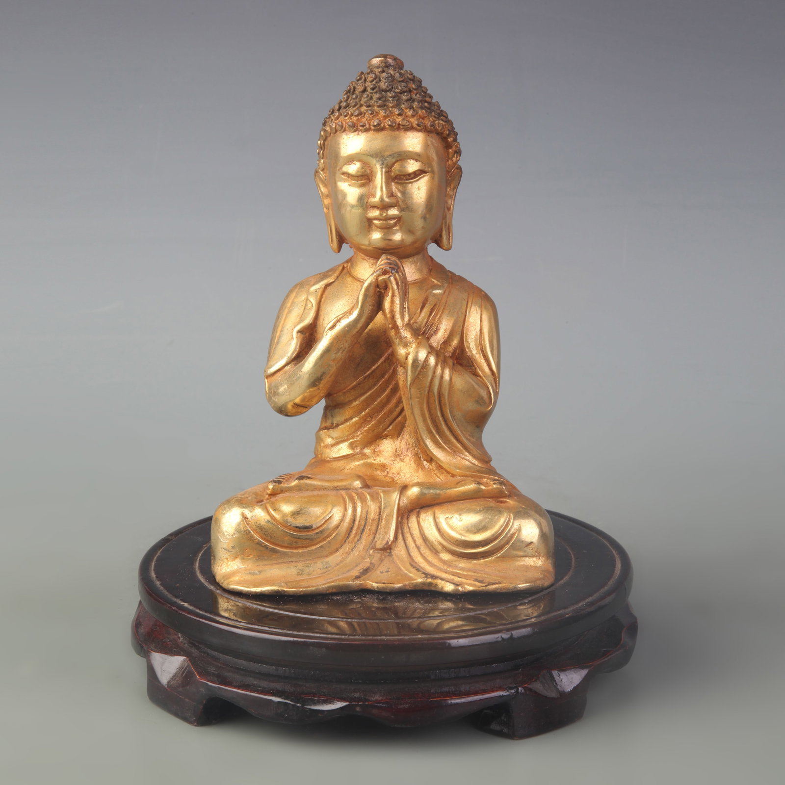 A SMALL BRONZE SHAKYAMUNI BUDDHA STATUE: Qing Dynasty; High: 6.6 inch; Wooden base for diplay only