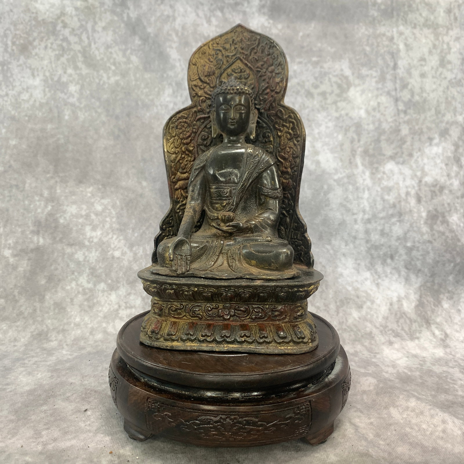 A FINE BRONZE SHAKYAMUNI BUDDHA WITH MANDORLA: 19th Century; Long: 4.7 inch; Width: 3.7 inch; High: 8.8 inch; Wooden base for diplay only