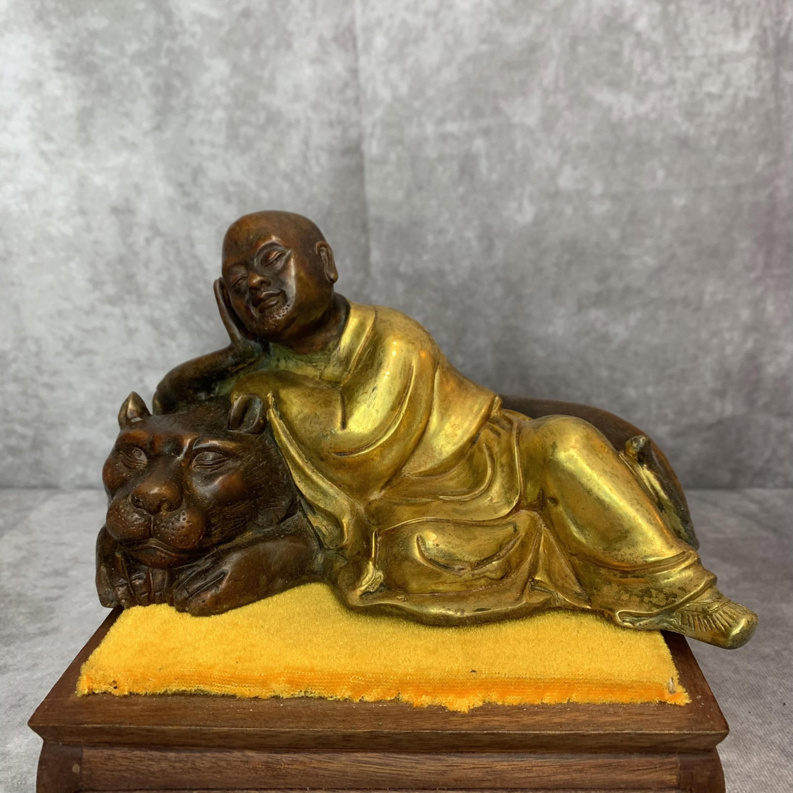 A FINE BRONZE MADE LU HAN FIGURE: 20th Century; High: 4.2 inch; Width: 6.9 inch; Long: 4.1 inch; Wooden base for diplay only