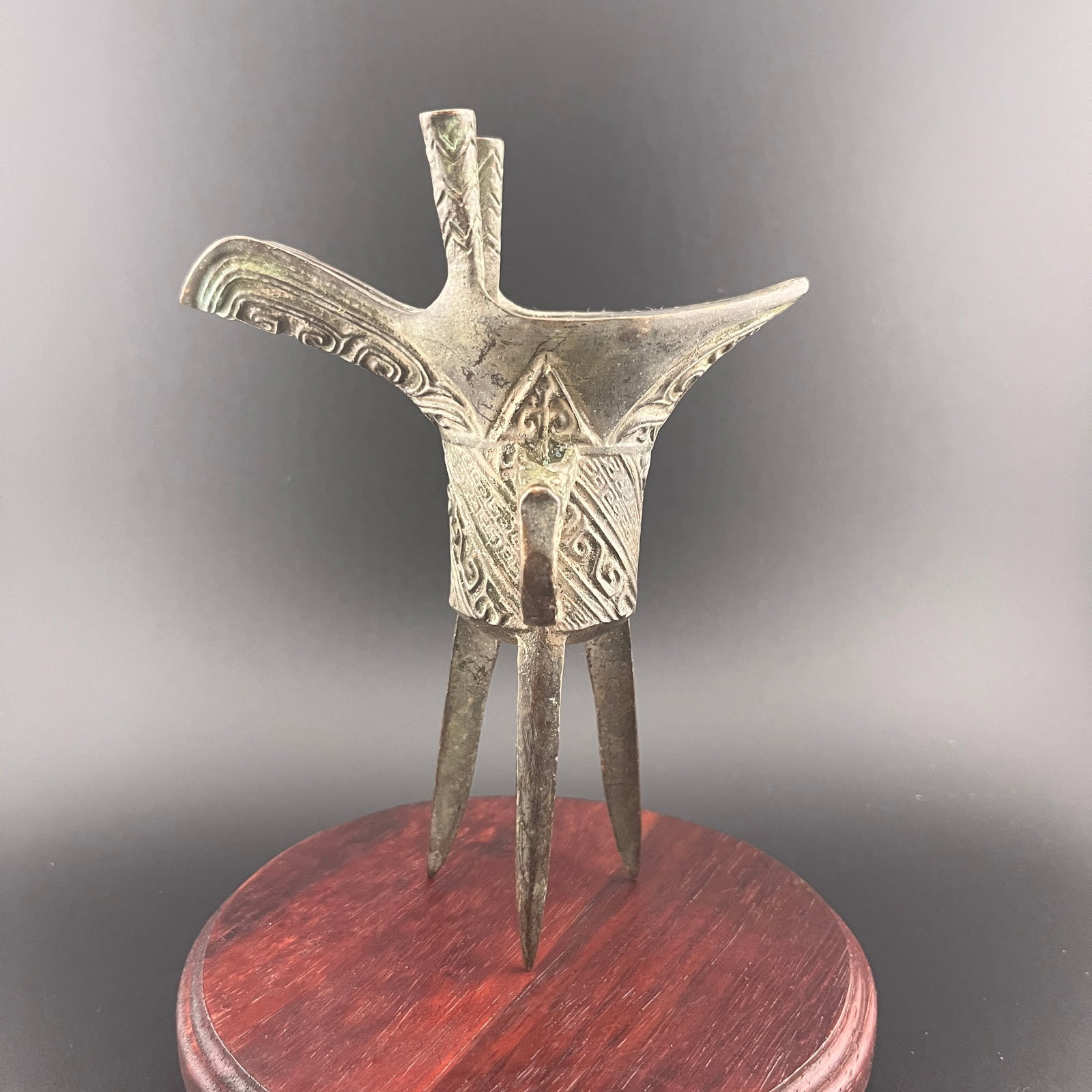 A FINE ARCHAIC BRONZE RITUAL WINE VESSEL: Zhou Dynasty Style; Long: 4.4 inch; Width: 2.2 inch; High: 6 inch; Wooden base for diplay only