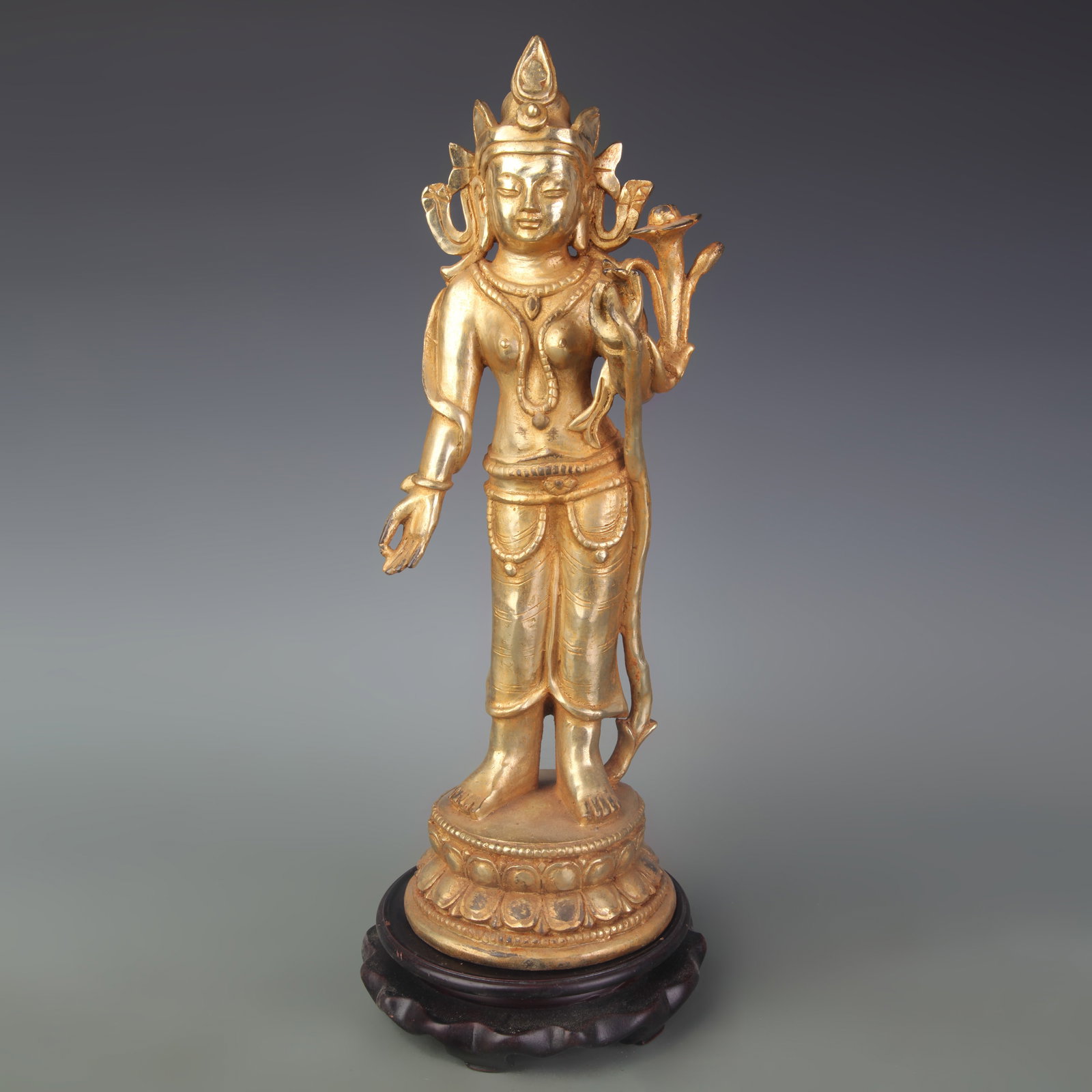 A FINE GILT BRONZE AVALOKITESHVARA (THE BODHISATTVA OF COMPASSION) STATUE: Qing Dynasty; Width: 5.0 inch; High: 13.6 inch; Wooden base for diplay only