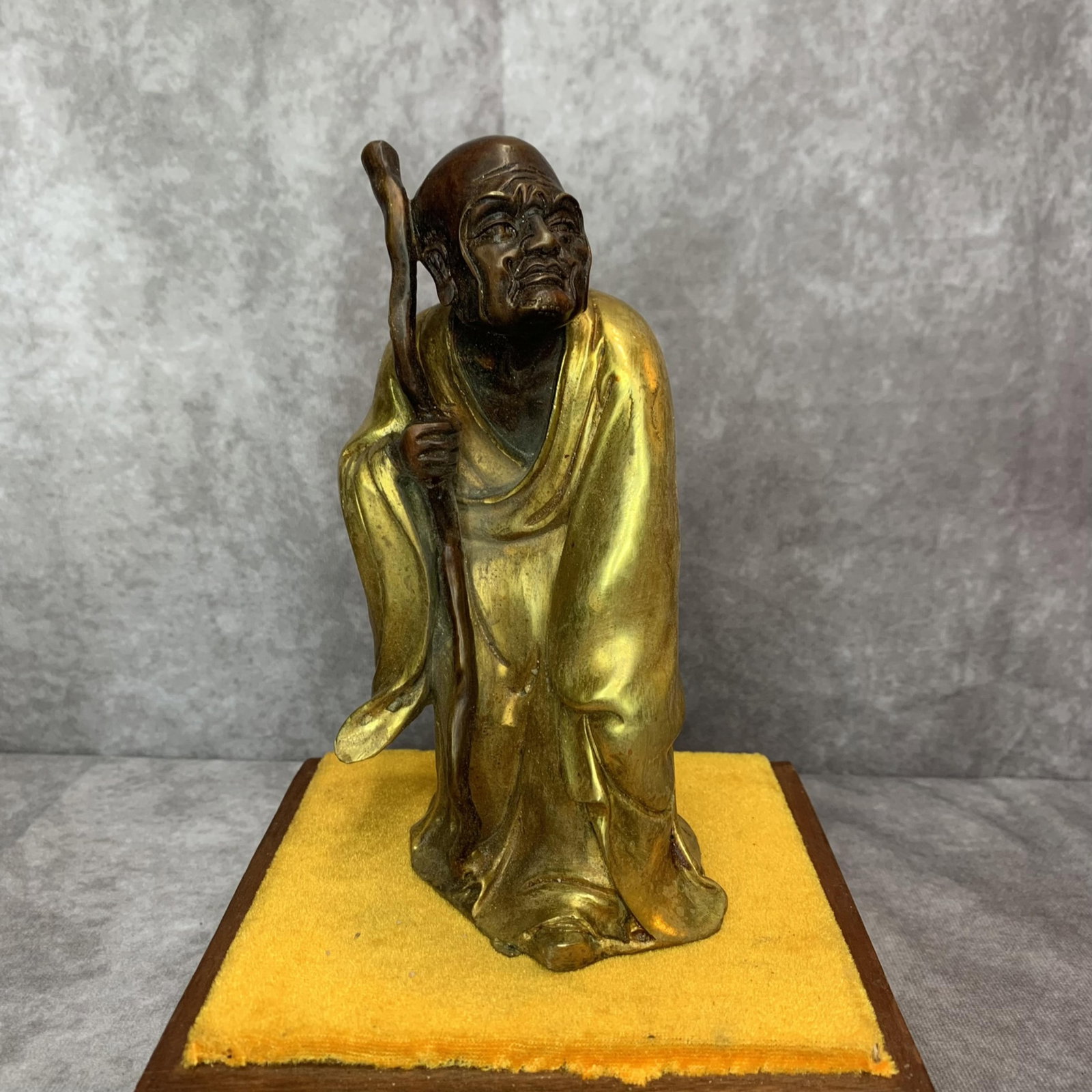 A FINE BRONZE MADE LU HAN FIGURE: 20th Century; High: 7.3 inch; Width: 2.9 inch; Long: 3.5 inch; Wooden base for diplay only