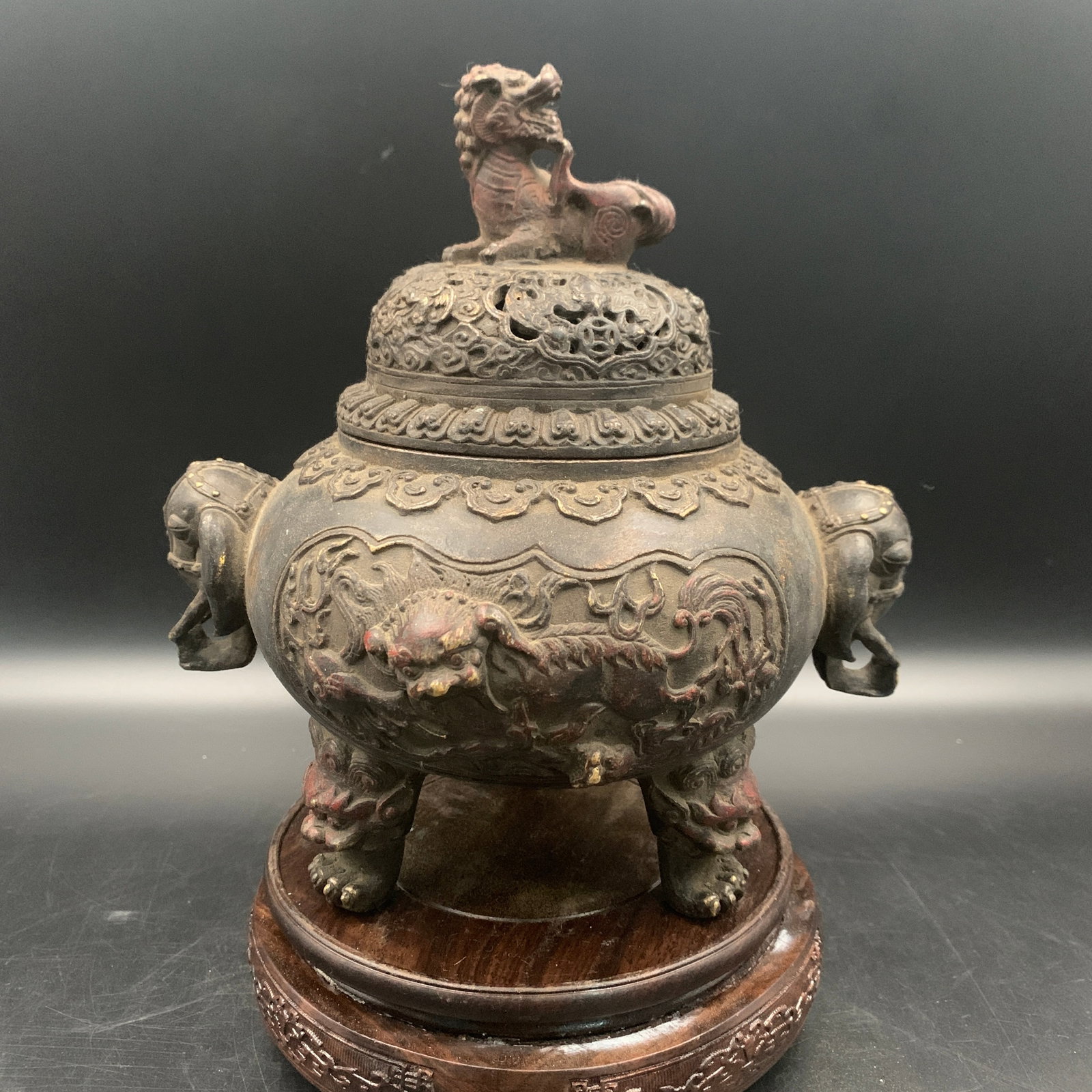 A BRONZE TRIPOD 'BUDDHIST LIONS' CENSER AND COVER