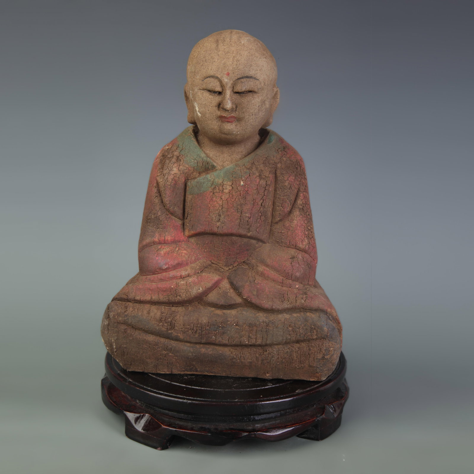 A POLYCHROME CARVED WOOD FIGURE OF BUDDHA (1 of 5)