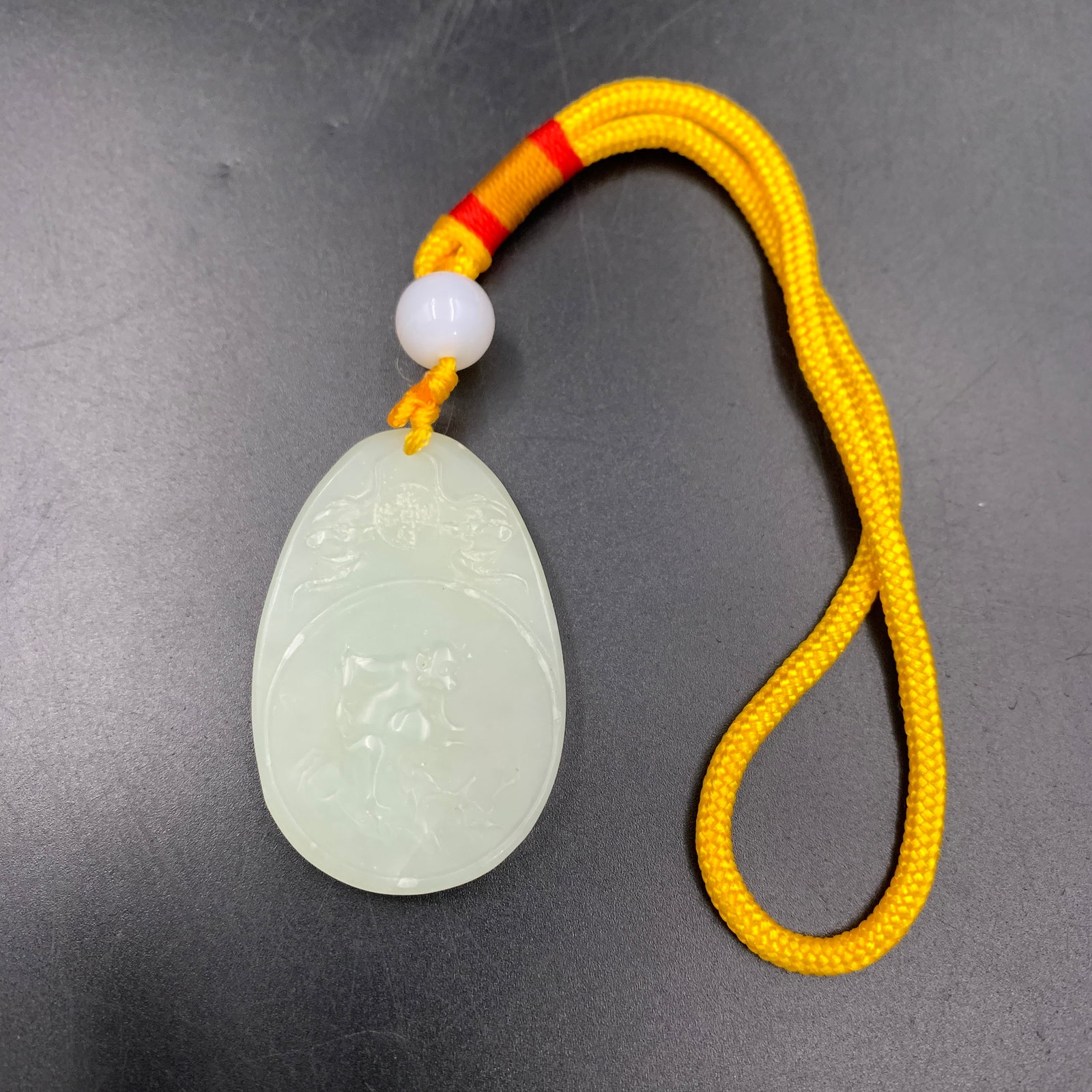 WHITE JADEITE "FACE OF GUANYIN" PORTRAIT PENDANT
