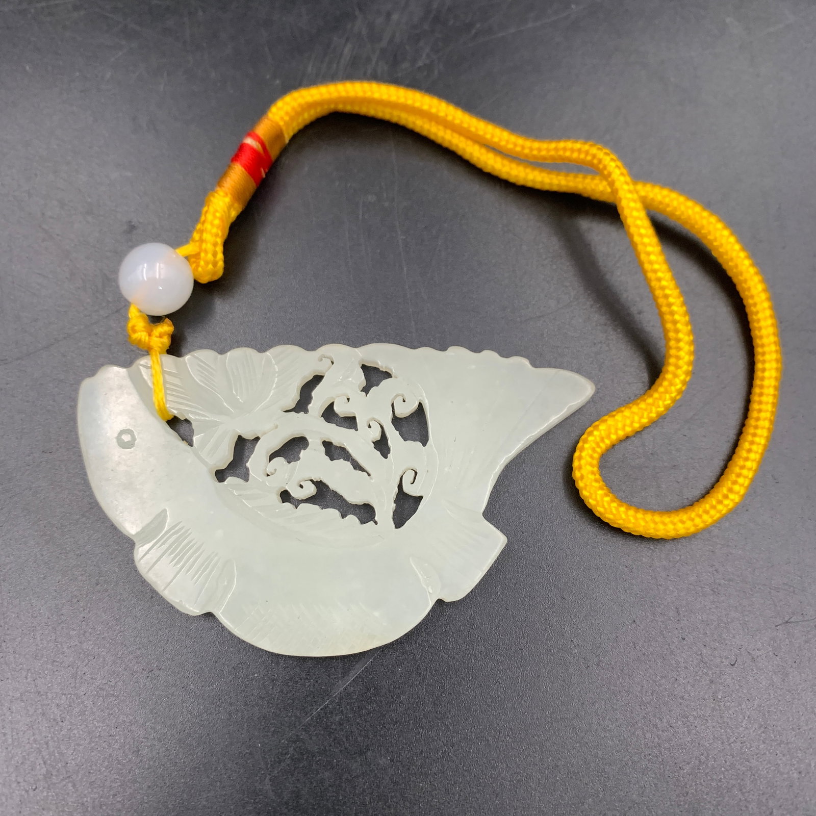 WHITE JADEITE "LOTUS AND CARP" FAN-SHAPED PENDANT