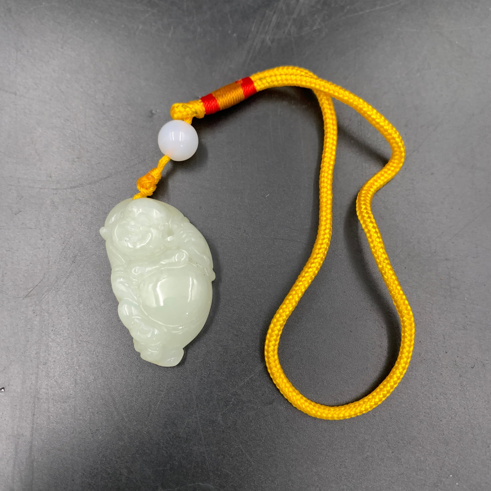 WHITE JADEITE SEATED LAUGHING BUDDHA PEBBLE PENDANT