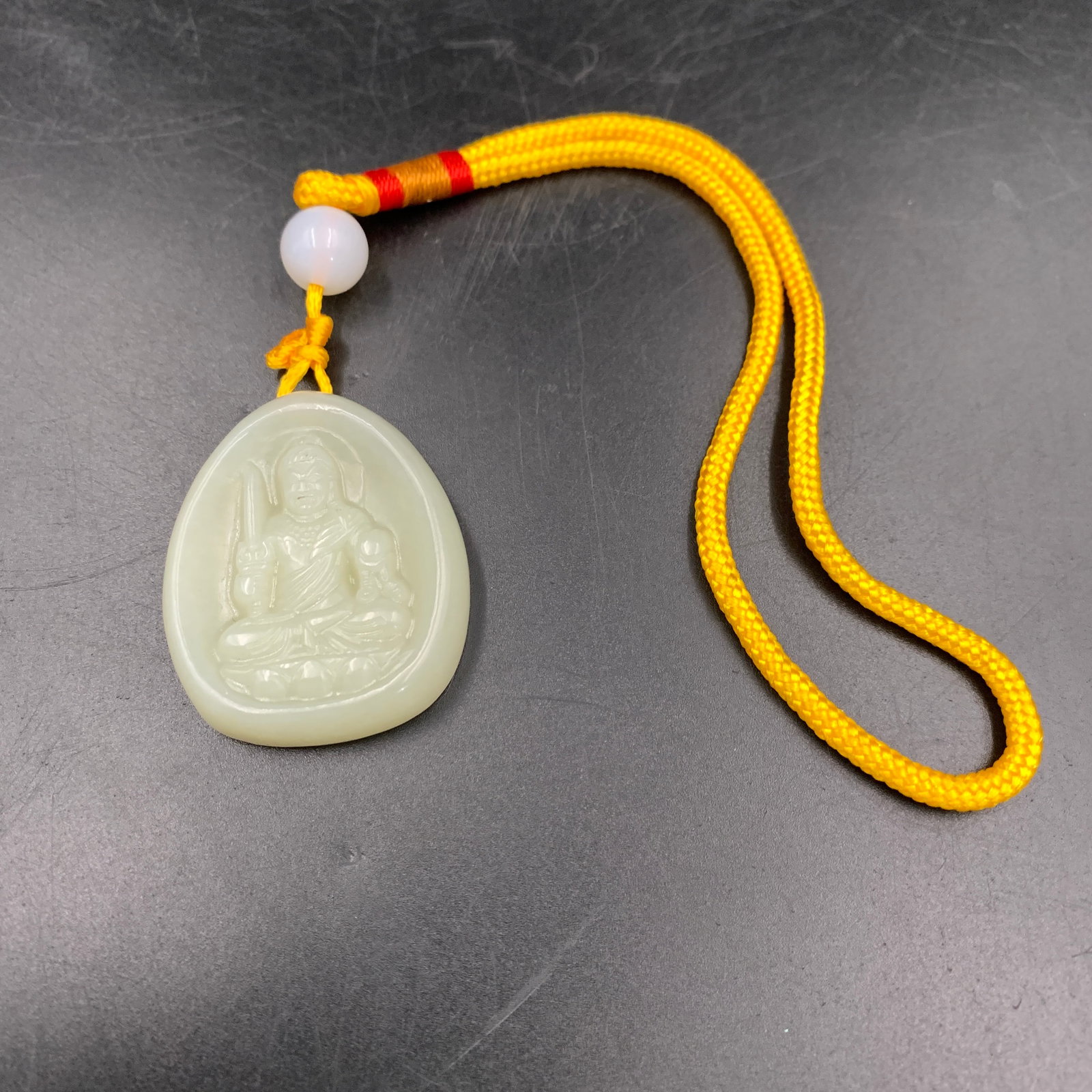 CARVED WHITE JADEITE ACALA BUDDHA PENDANT