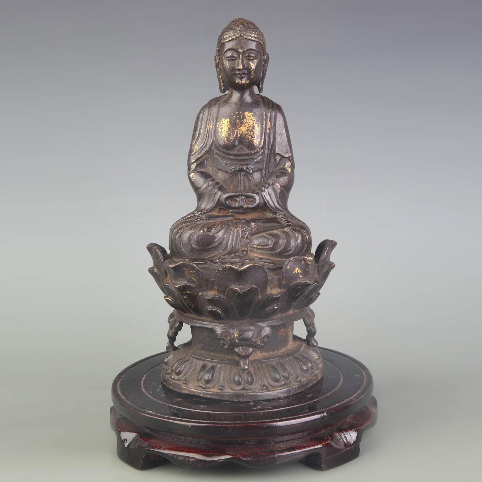 A SEATED BRONZE FIGURE OF GUANYIN: Qing Dynasty; High: 9.1 inch; Wooden base for diplay only
