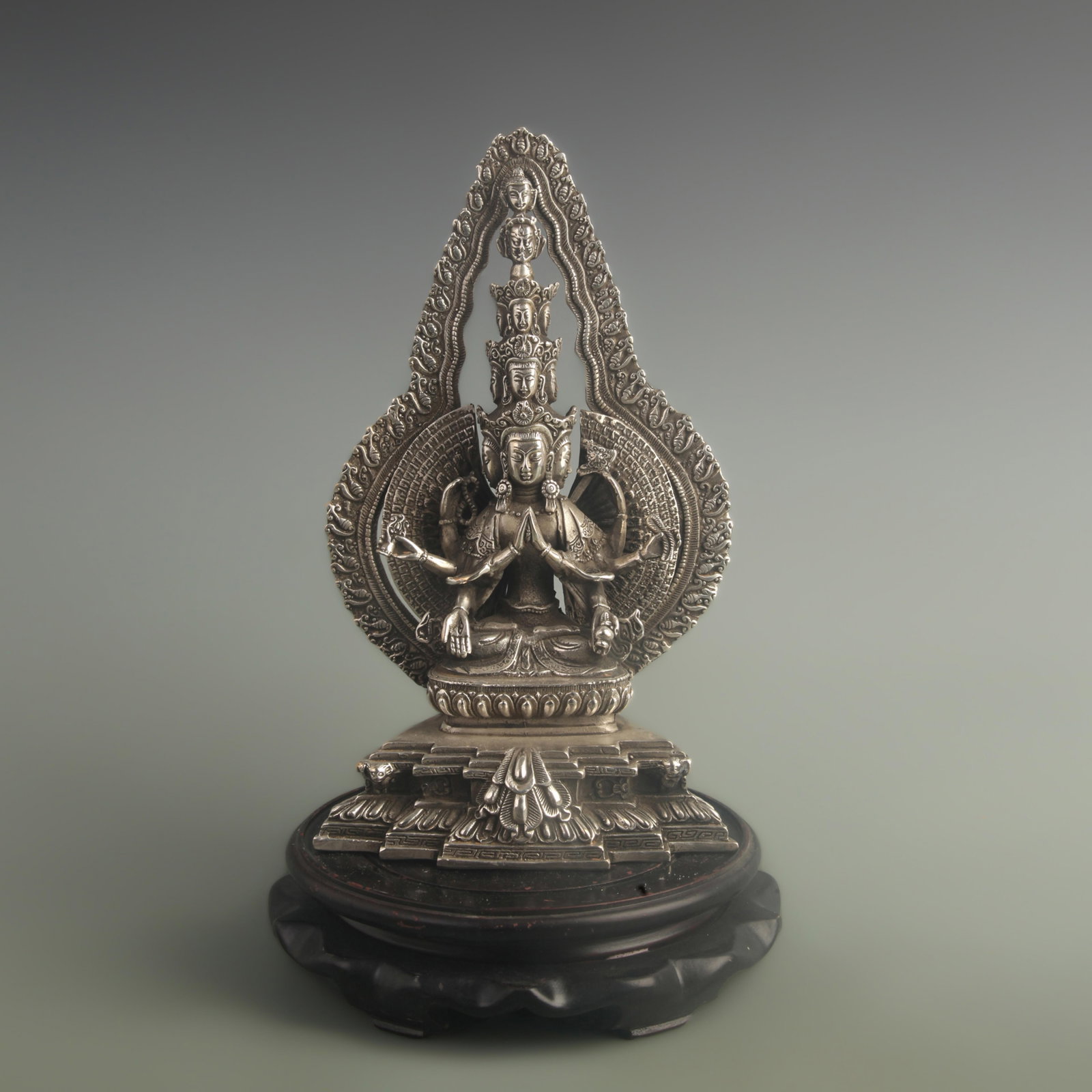 SILVER-GILT BRONZE EIGHT-ARMED GUANYIN FIGURE: 20th Century; High: 11.0 inch; Width: 3.50 inch; Long: 6.20 inch; Wooden base for diplay only