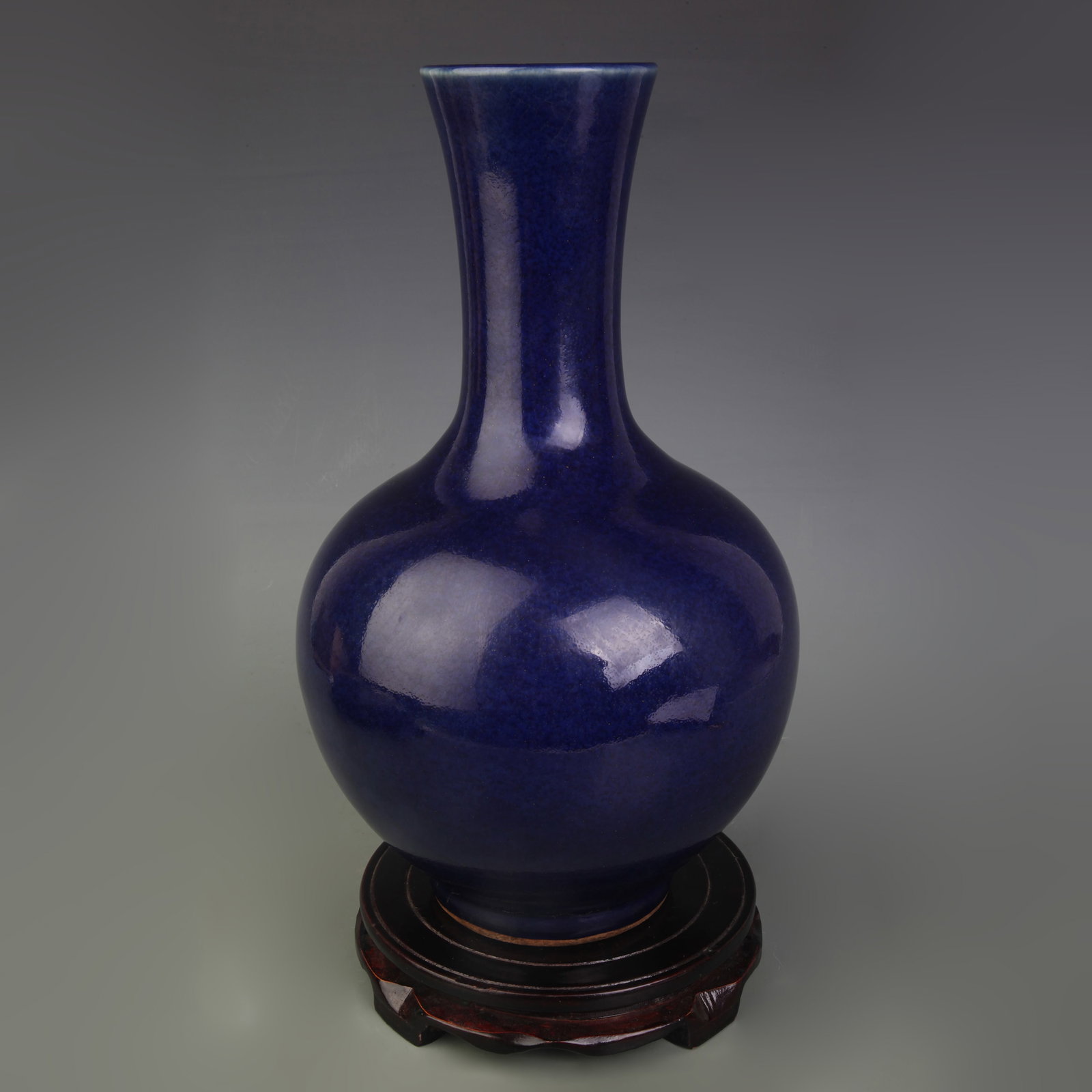 A SACRIFICIAL-BLUE-GLAZED TIANQIUPING (GLOBULAR VASE): Qing Dynasty Yong Zheng Period; High: 12.9 inch; Wooden base for diplay only