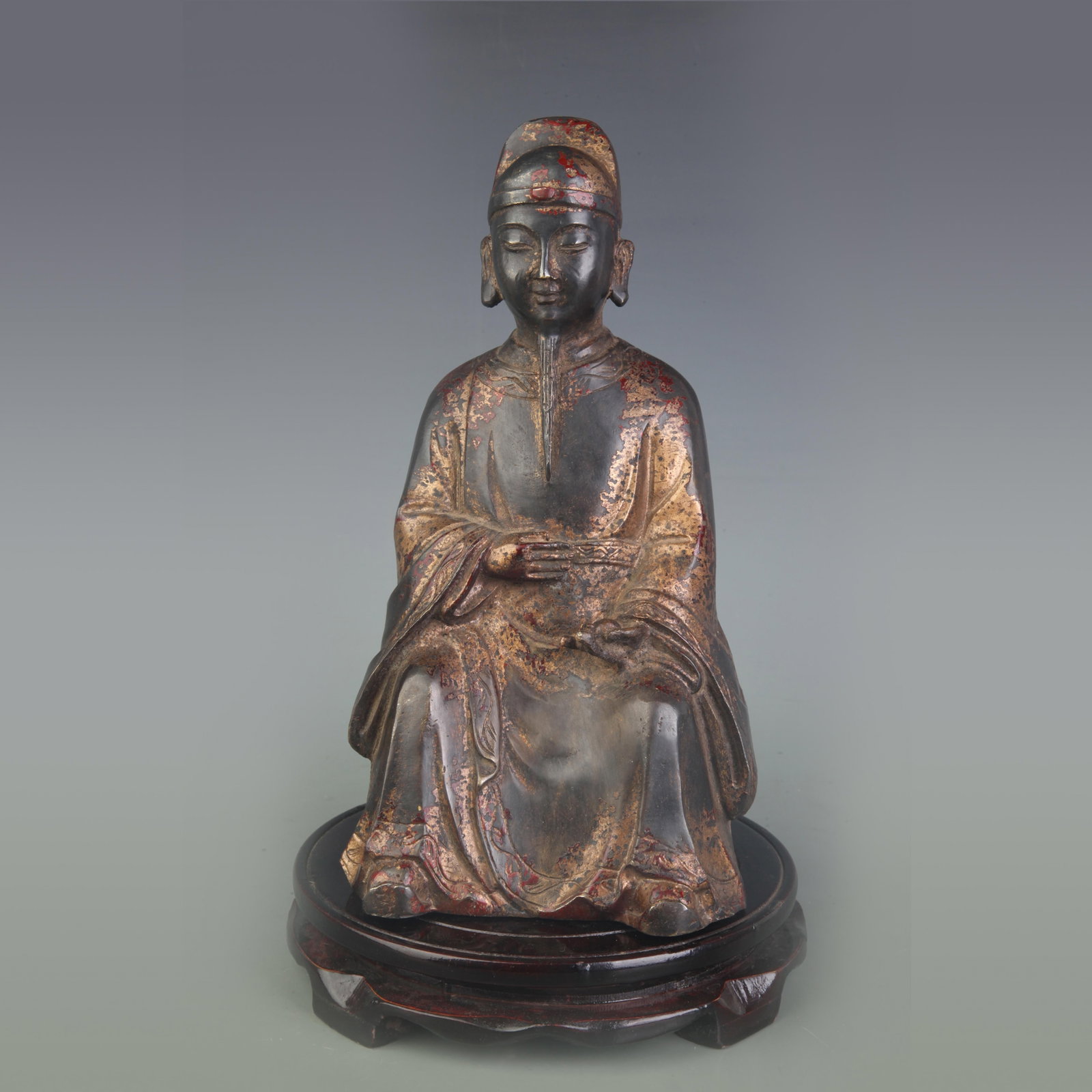 A FINE GILT-LACQUERED BRONZE FIGURE OF A SEATED COURT OFFICIAL