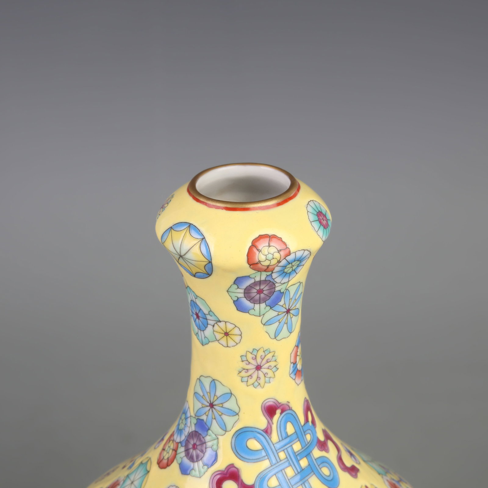 A FAMILLE-ROSE YELLOW-GROUND FLORAL PATTERN PORCELAIN VASE: Qing Dynasty Yong Zheng Period; Diameter: 5.8 inch; High: 9.8 inch; Wooden base for diplay only