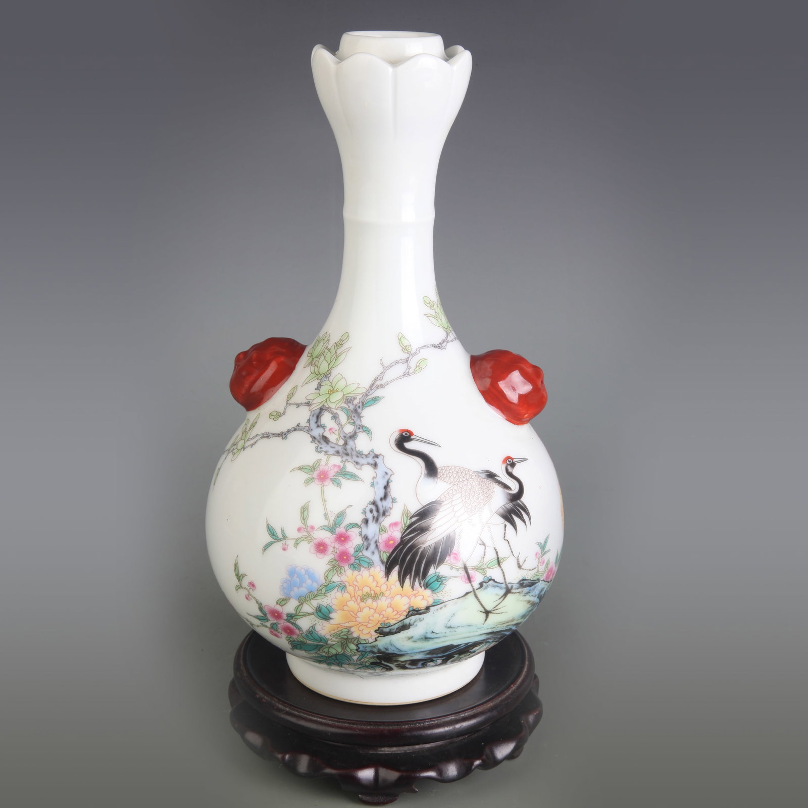 A FAMILLE ROSE FLOWER AND BIRD VASE WITH BEAST HANDLES: Qing Dynasty Qian Long Period; Diameter: 3.1 inch; High: 10.0 inch; Wooden base for diplay only