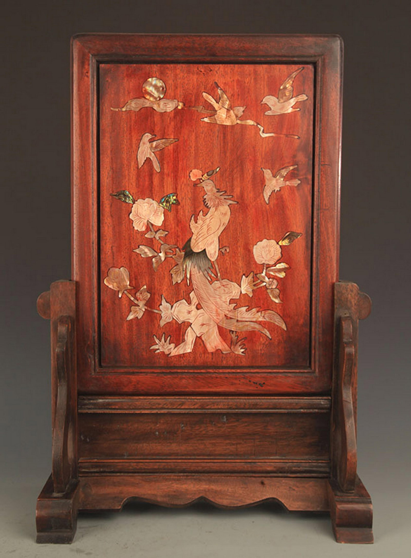 A WOOD TABLE PLAQUE INLAID WITH MOTHER-OF-PEARL
