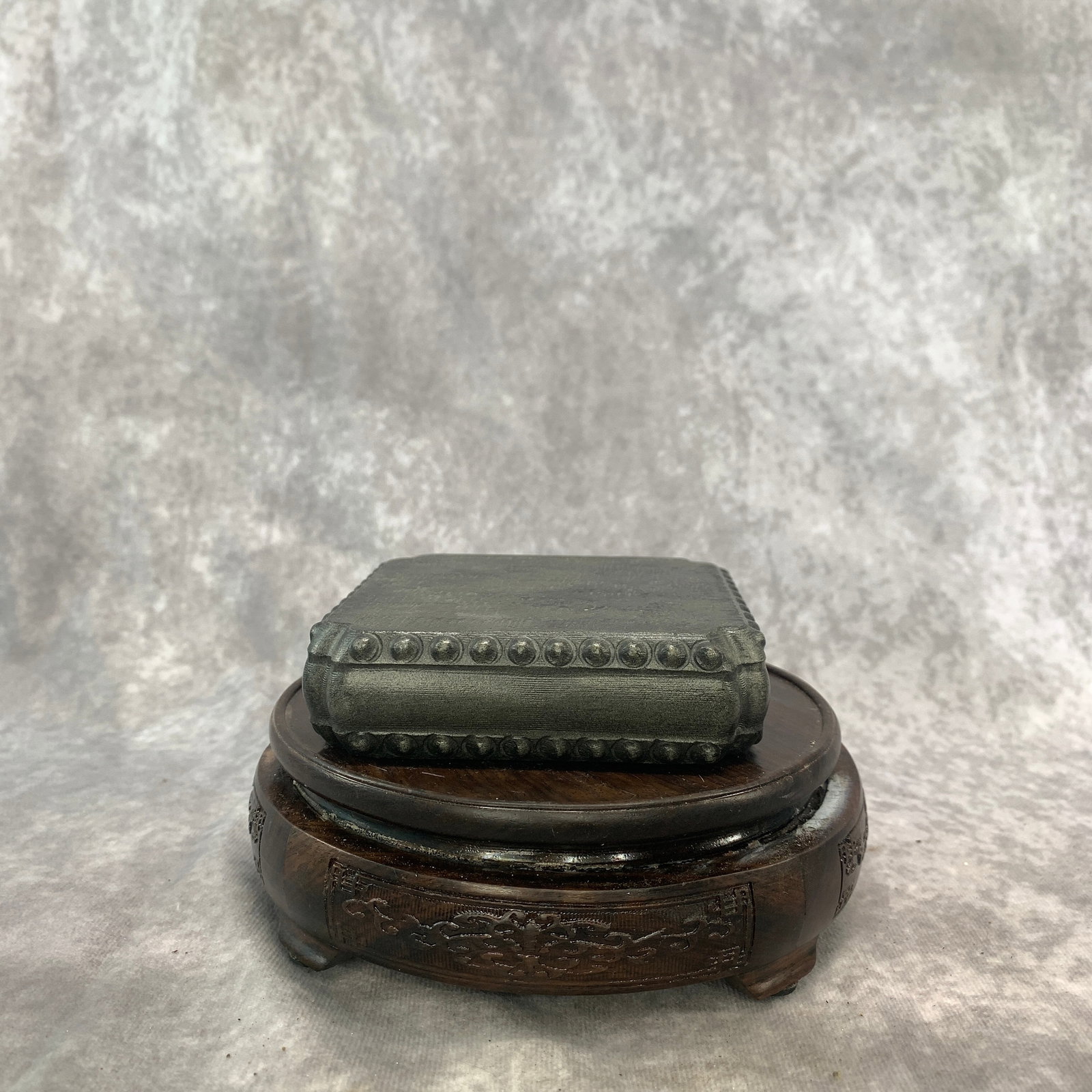 A FINE STONE DRUM-FORM SQUARE BASE