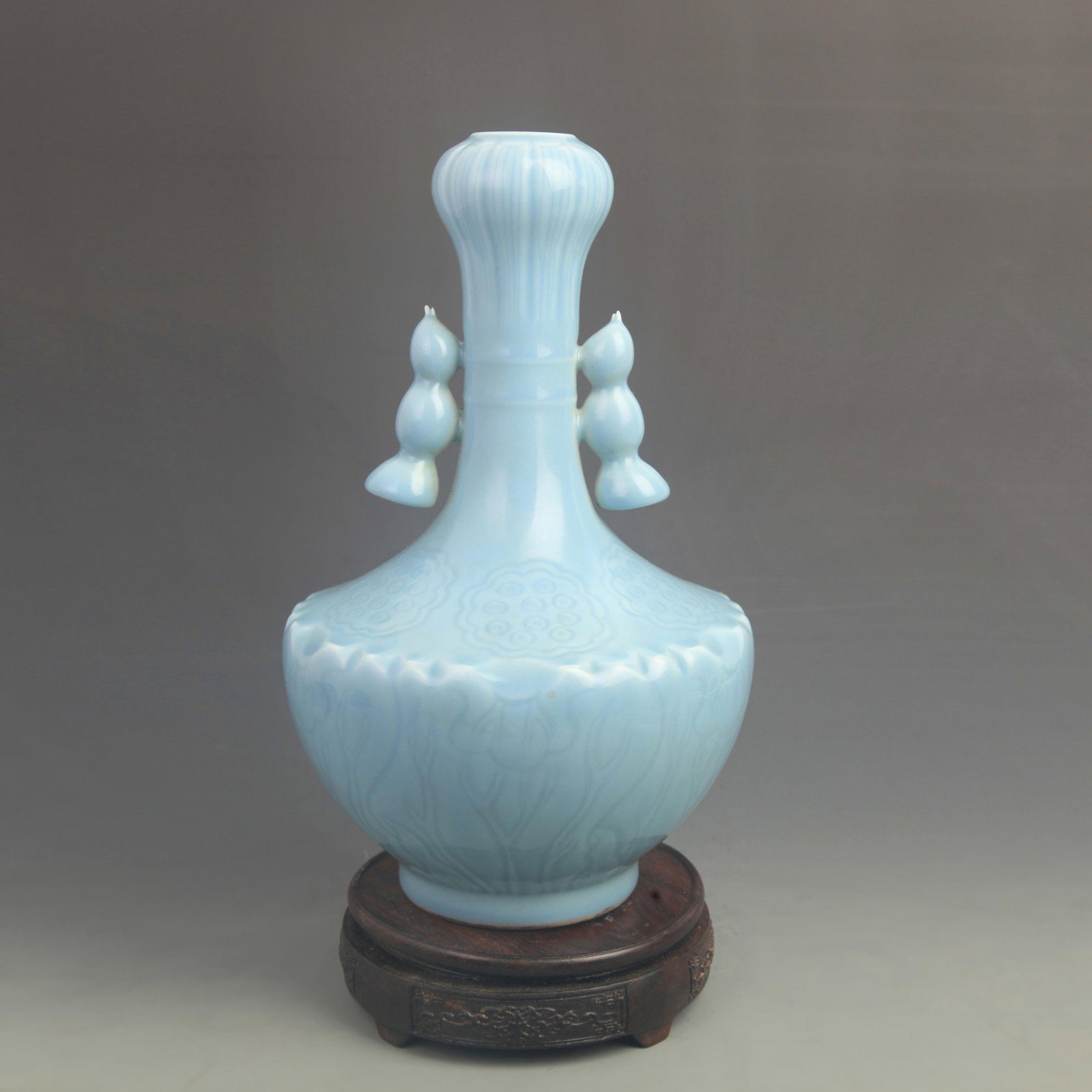 A SKY-BLUE GLAZED DOUBLE-HANDLED GARLIC-HEAD VASE: Qing Dynasty Qian Long Period; High: 13.0 inch; Diameter: 7.80 inch; Wooden base for diplay only