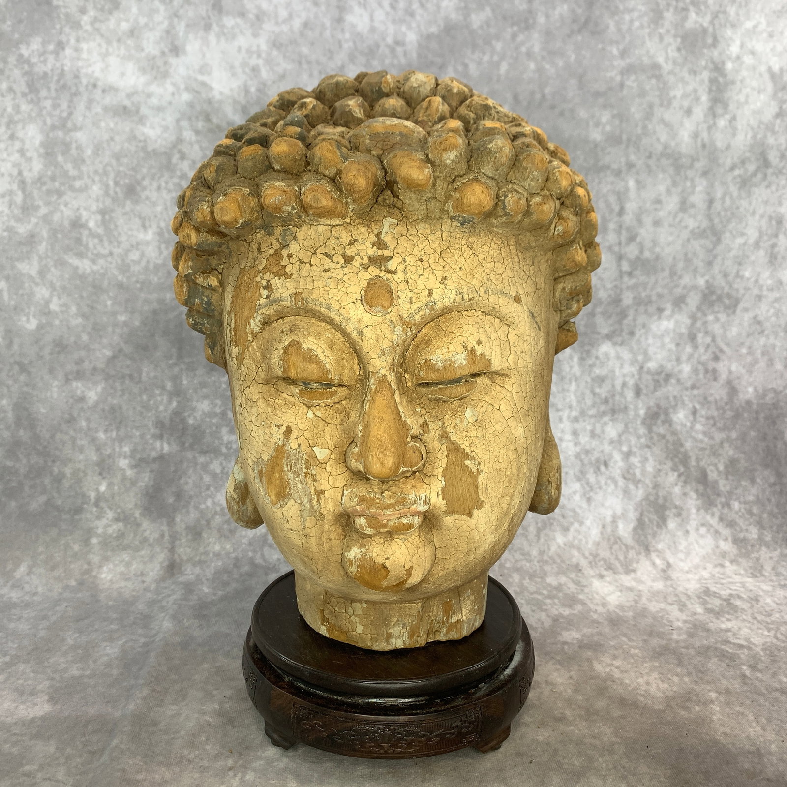 A FINE PAINTED WOOD BUDDHA HEAD FIGURE: Qing Dynasty; Long: 8.2 inch; Width: 8.2 inch; High: 12 inch; Wooden base for diplay only