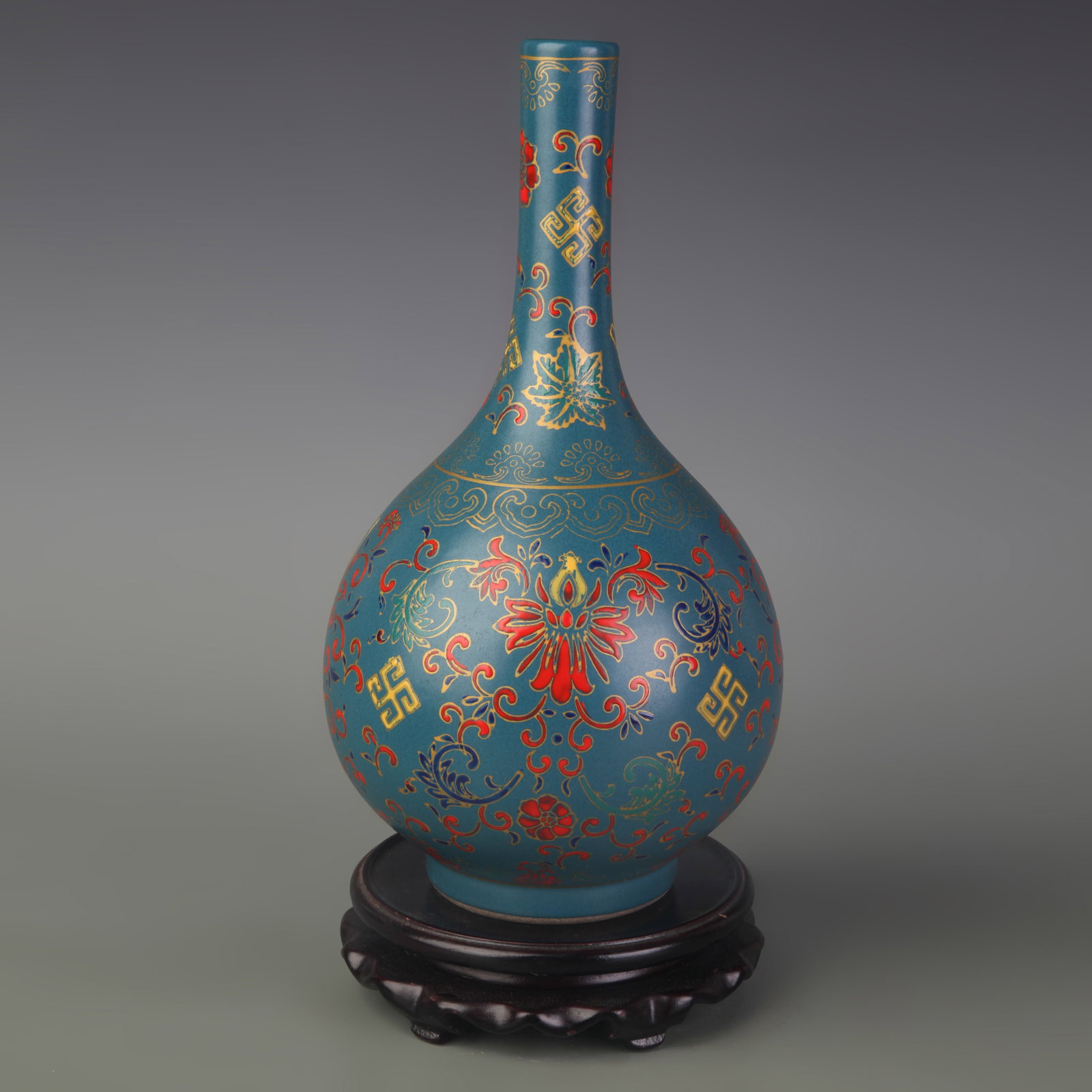 A GREEN-GLAZED VASE WITH OVERGLAZE FLORAL DECORATION