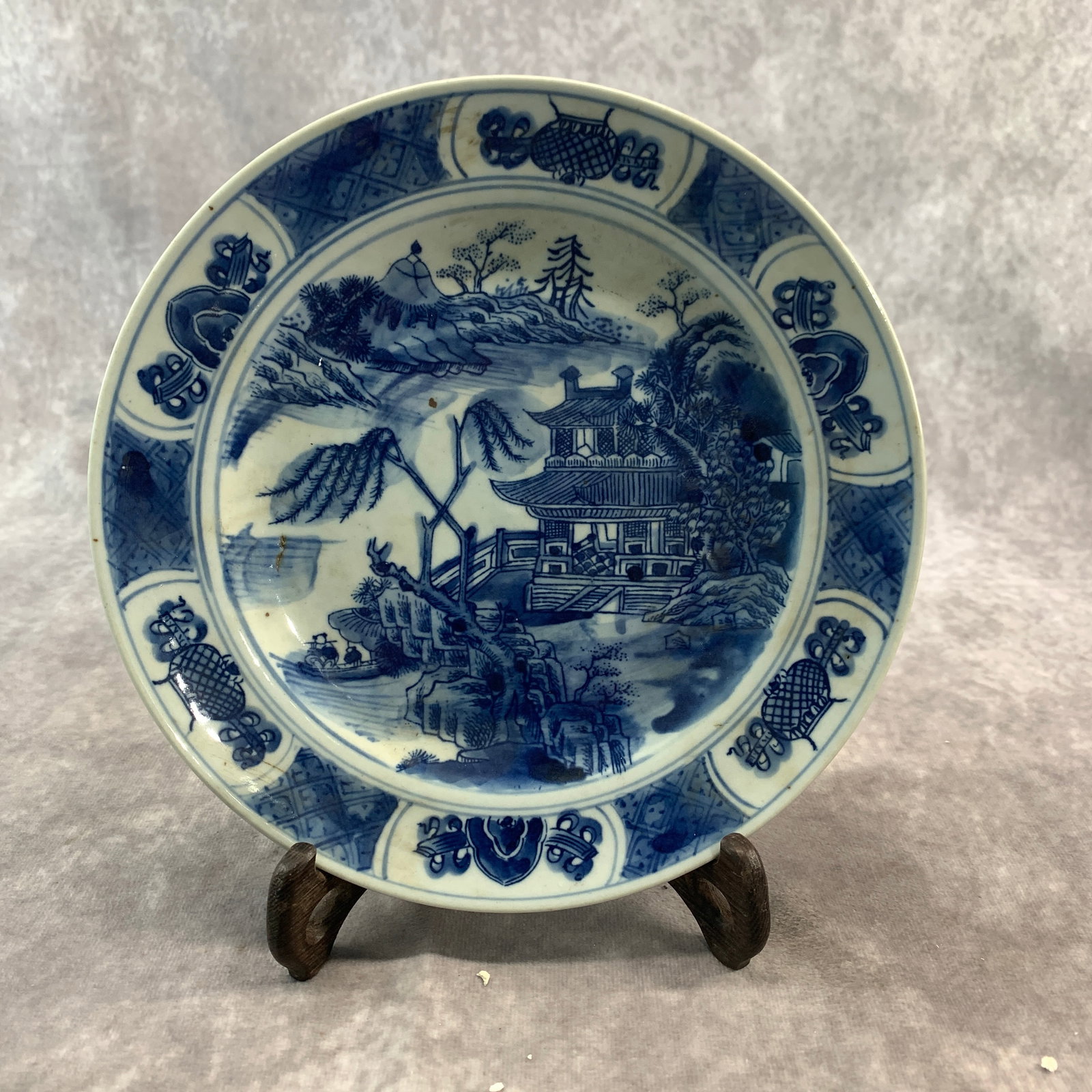 A FINE BLUE AND WHITE LANDSCAPE PORCELAIN PLATE: Ming Dynasty Style; High: 1.1 inch; Diameter: 8.3 inch; Wooden base for diplay only