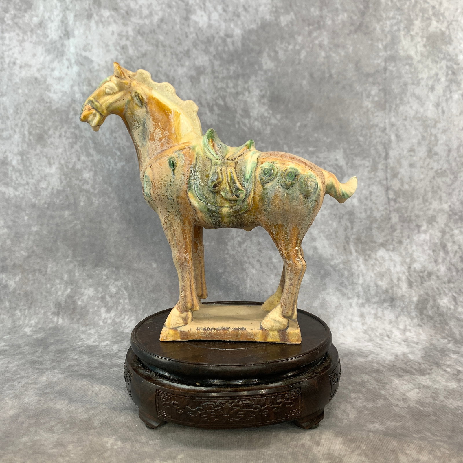 A SANCAI-GLAZED POTTERY FIGURE OF A CAPARISONED STANDING HORSE