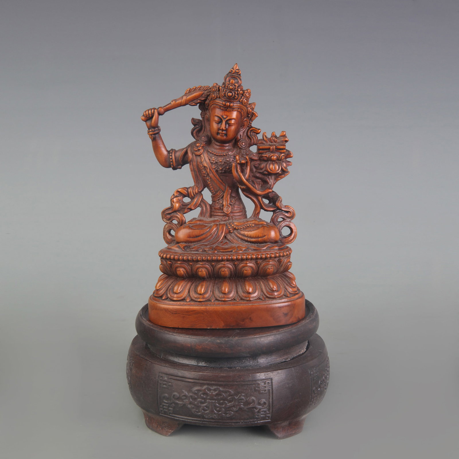 A BOXWOOD FIGURE OF MANJUSHRI BODHISATTVA