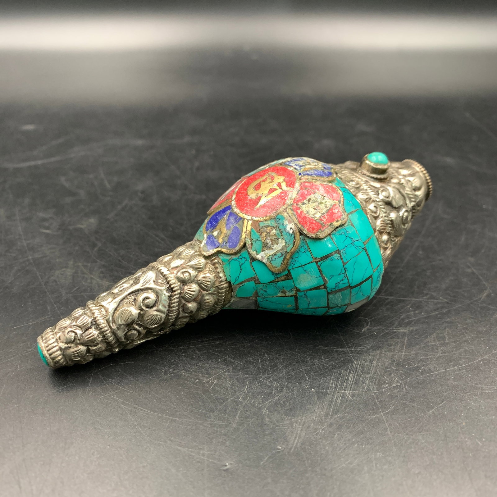 TIBETAN BUDDHIST CORAL AND TURQUOISE INLAID RITUAL CONCH SHELL: Qing Dynasty; Long: 5.3 inch; Width: 2.3 inch; High: 1.9 inch; Wooden base for diplay only