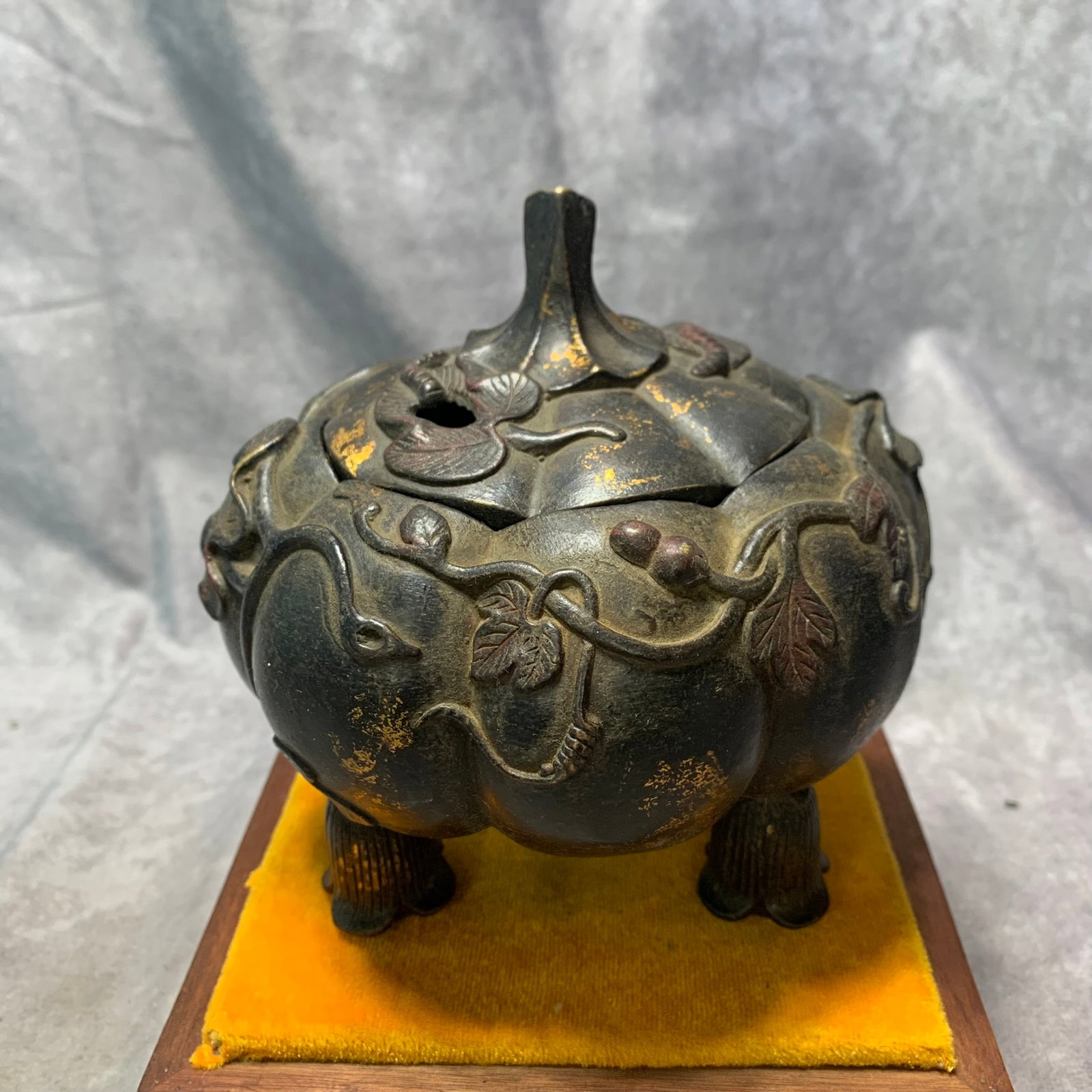 A BRONZEXUANDE MARK INCENSE BURNER WITH FRUIT MOTIF