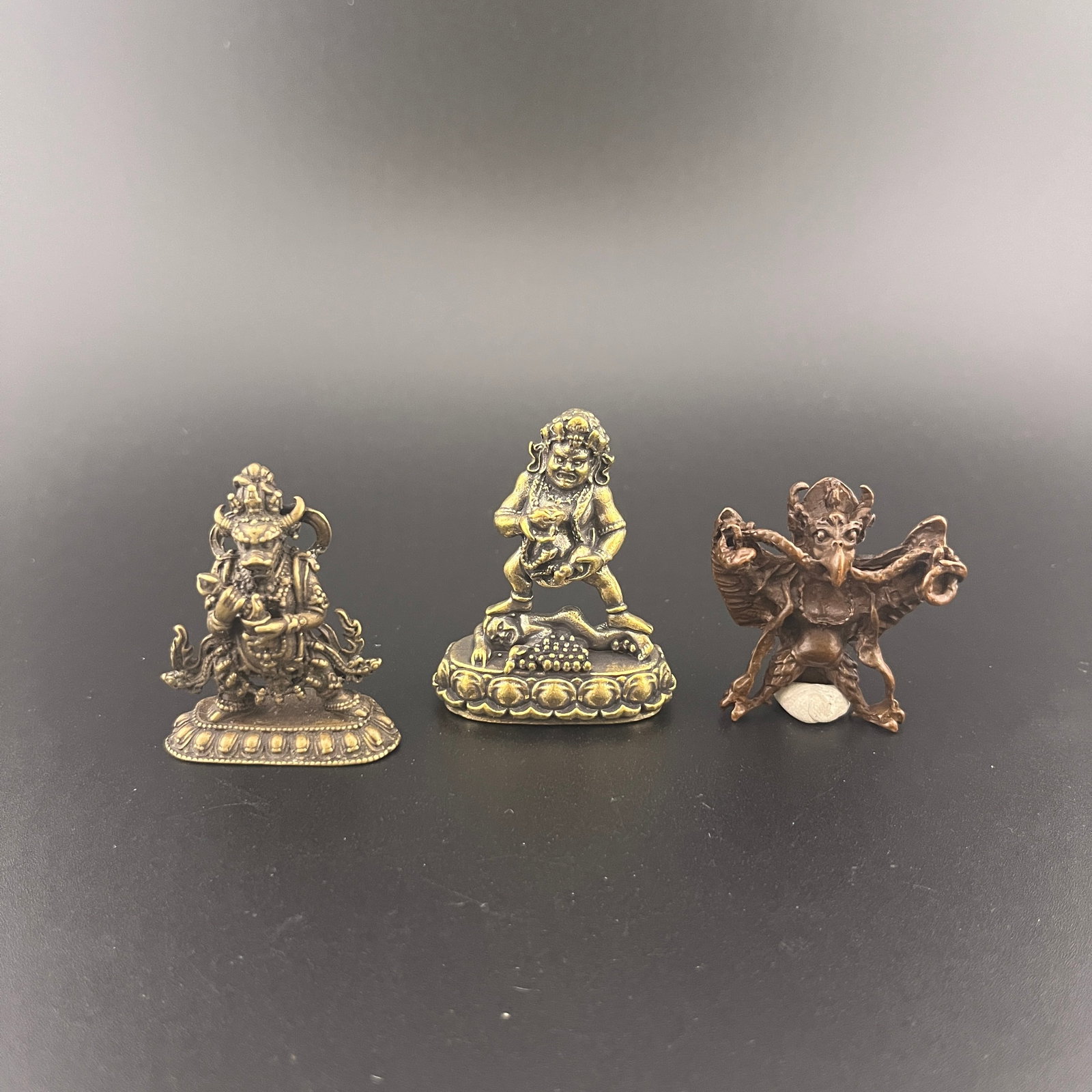GROUP TIBETAN BUDDHA STATUE PENDANT: Modern; Long: 1.5 inch; Width: 0.78 inch; High: 1.88 inch; Long: 1.38 inch; Width: 0.5 inch; High: 1.63 inch; Long: 1.3 inch; Width: 1.4 inch; High: 0.6 inch; Wooden base for diplay only