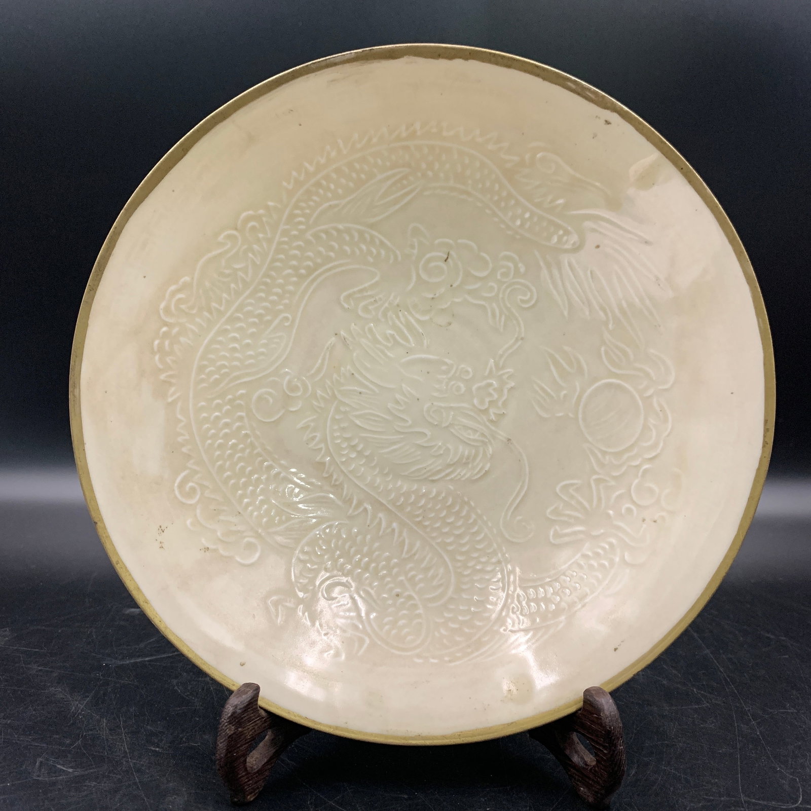 A DING-STYLE WHITE-GLAZED 'DRAGON AND FLAMING PEARL' PORCELAIN DISH