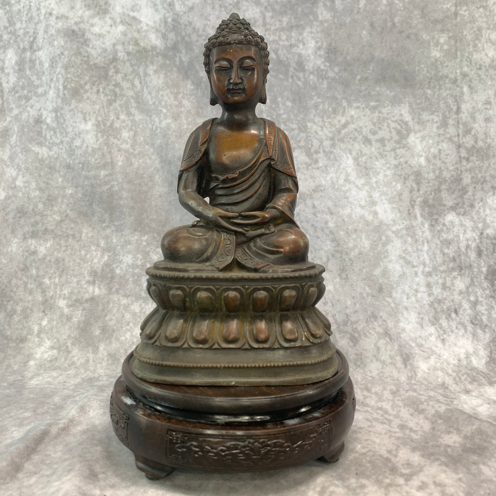 A FINE BRONZE SEATED SHAKYAMUNI BUDDHA: Qing Dynasty; Long: 5.3 inch; Width: 4 inch; High: 9.3 inch; Wooden base for diplay only