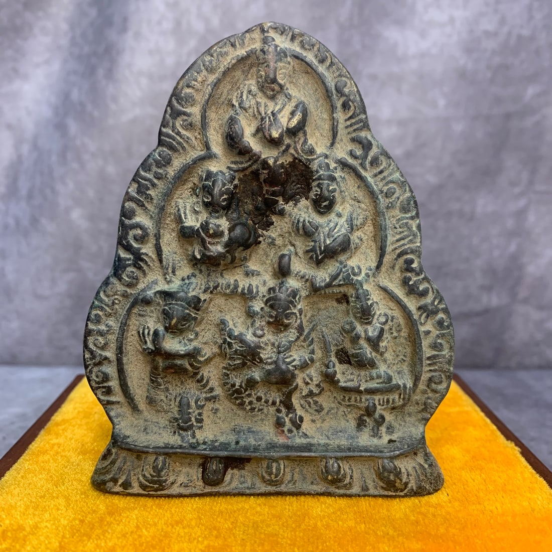 A SMALL BRONZE TIBETAN BRONZE SIX BUDDHAS OF WEALTH AMULET