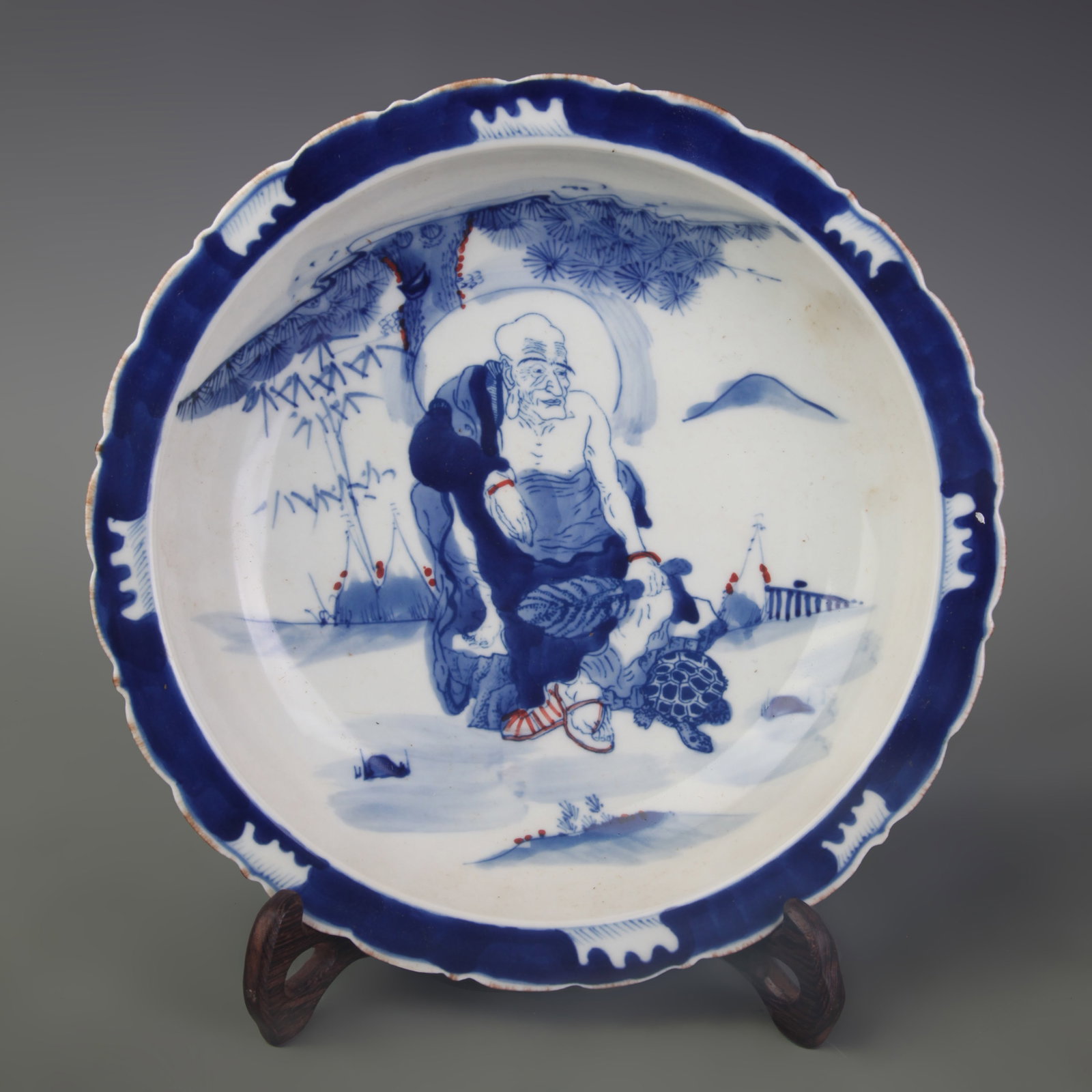 A BLUE-AND-WHITE UNDERGLAZE-RED FIGURAL PORCELAIN DISH