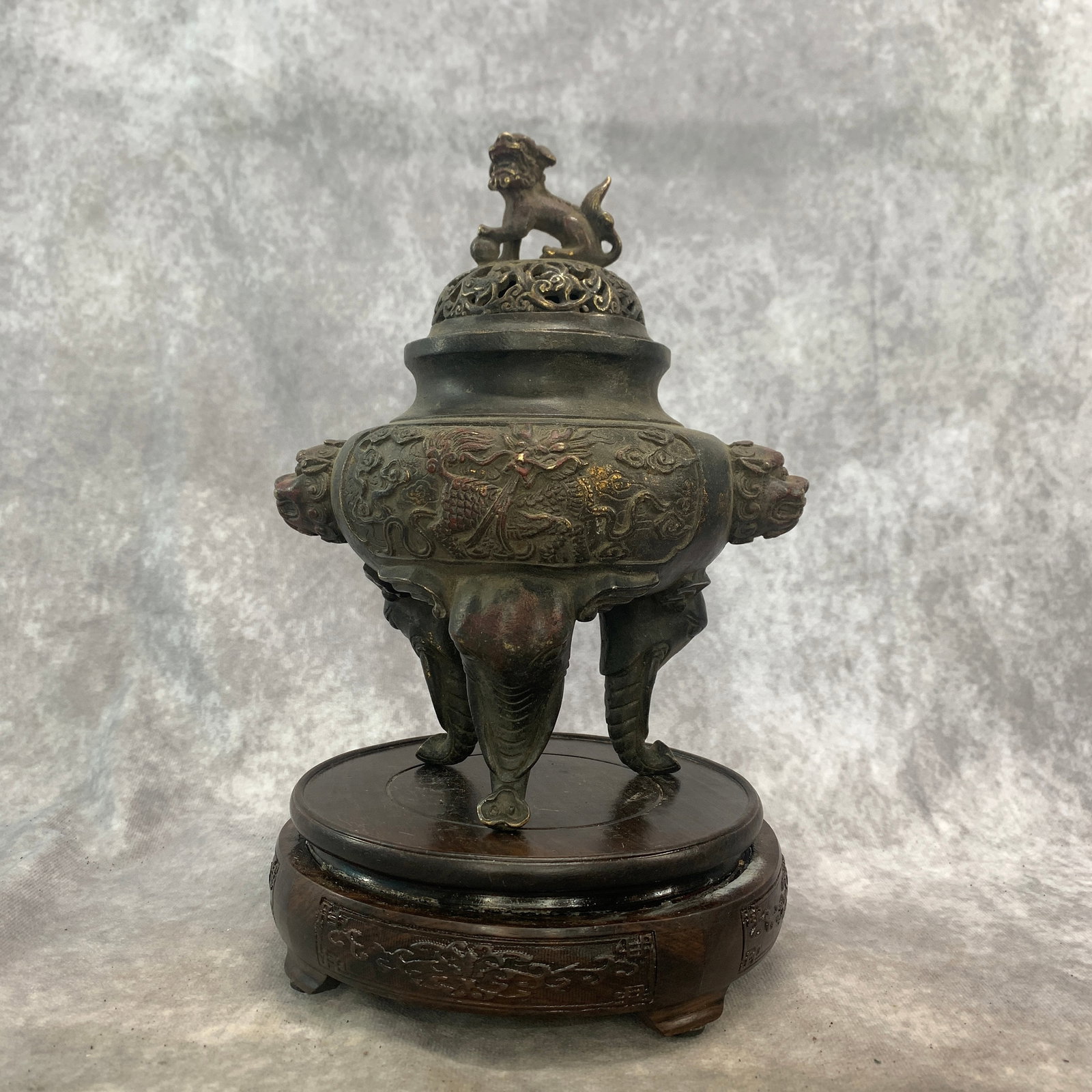 A FINE PATINATED BRONZE 'QILIN AND ELEPHANT-HEAD' TRIPOD CENSER AND COVER