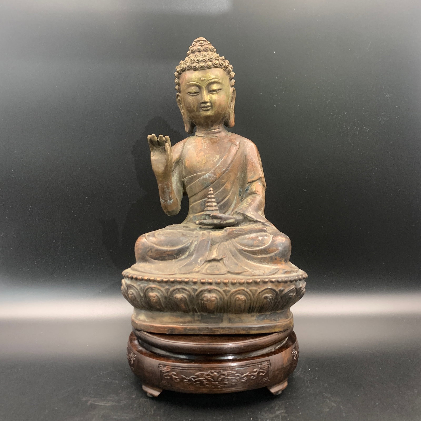 A CAST BRONZE FIGURE OF BHAISAJYAGURU, THE MEDICINE BUDDHA: Qing Dynasty; Long: 6.8 inch; Width: 4.9 inch; High: 11.4 inch; Wooden base for diplay only