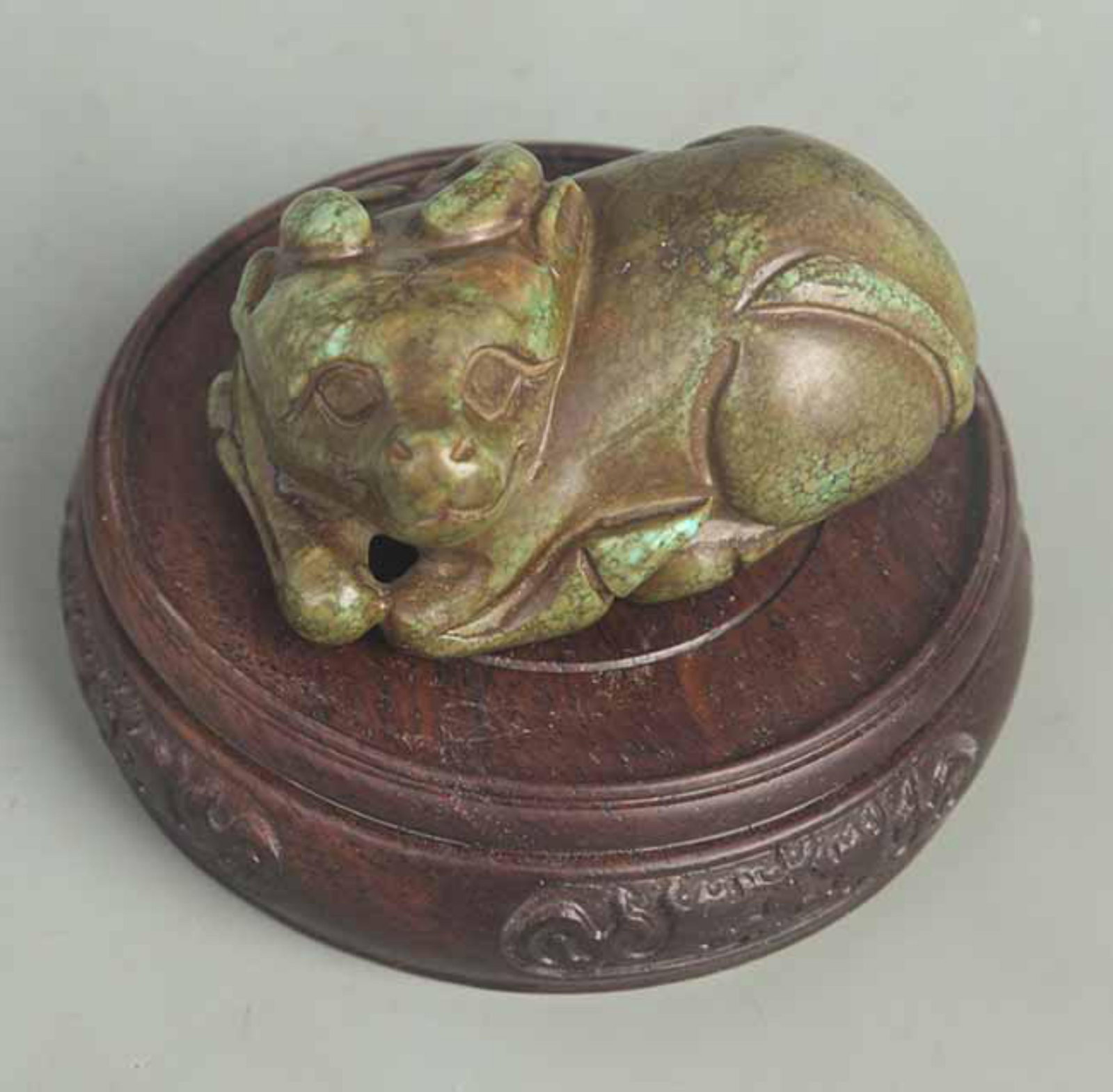 A TURQUOISE CARVED MYTHICAL BEAST: Qing Dynasty; High: 1.25 inch; Width: 1.75 inch; Long: 2.75 inch; Wooden base for diplay only