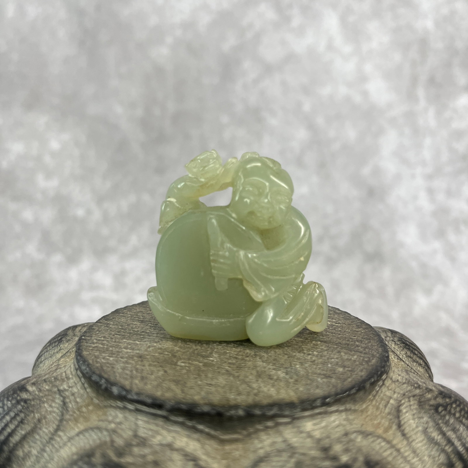 A FINE HETIAN JADE IN FIGURE OF BOY WITH DRUM: Qing Dynasty; Long: 1.7 inch; Width: 1.7 inch; High: 0.67 inch