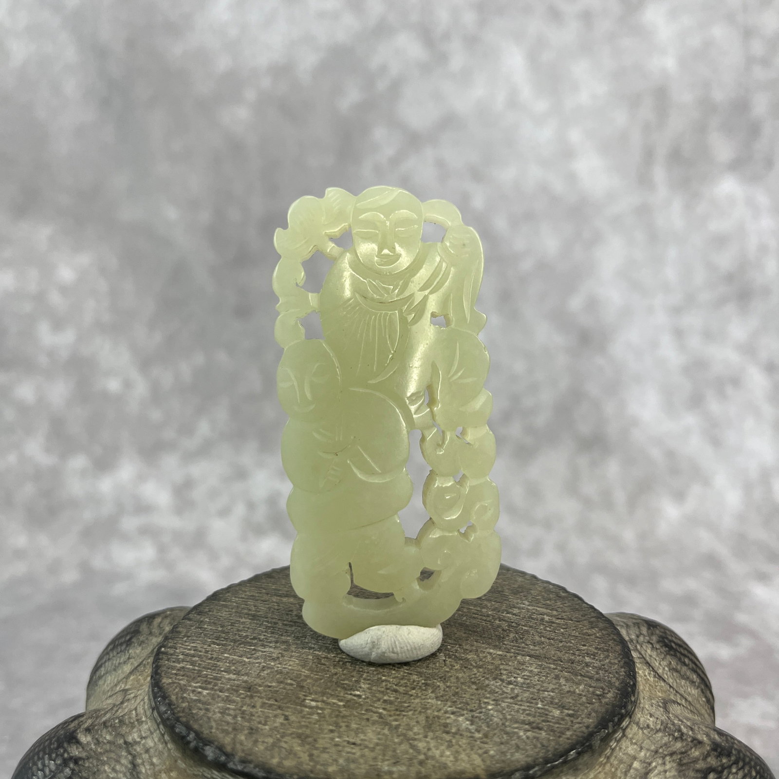 A FINE HETIAN JADE IN FIGURE OF HE-HE ERXIAN (THE IMMORTALS OF HARMONY): Qing Dynasty; Long: 2.7 inch; Width: 1.3 inch; High: 0.38 inch