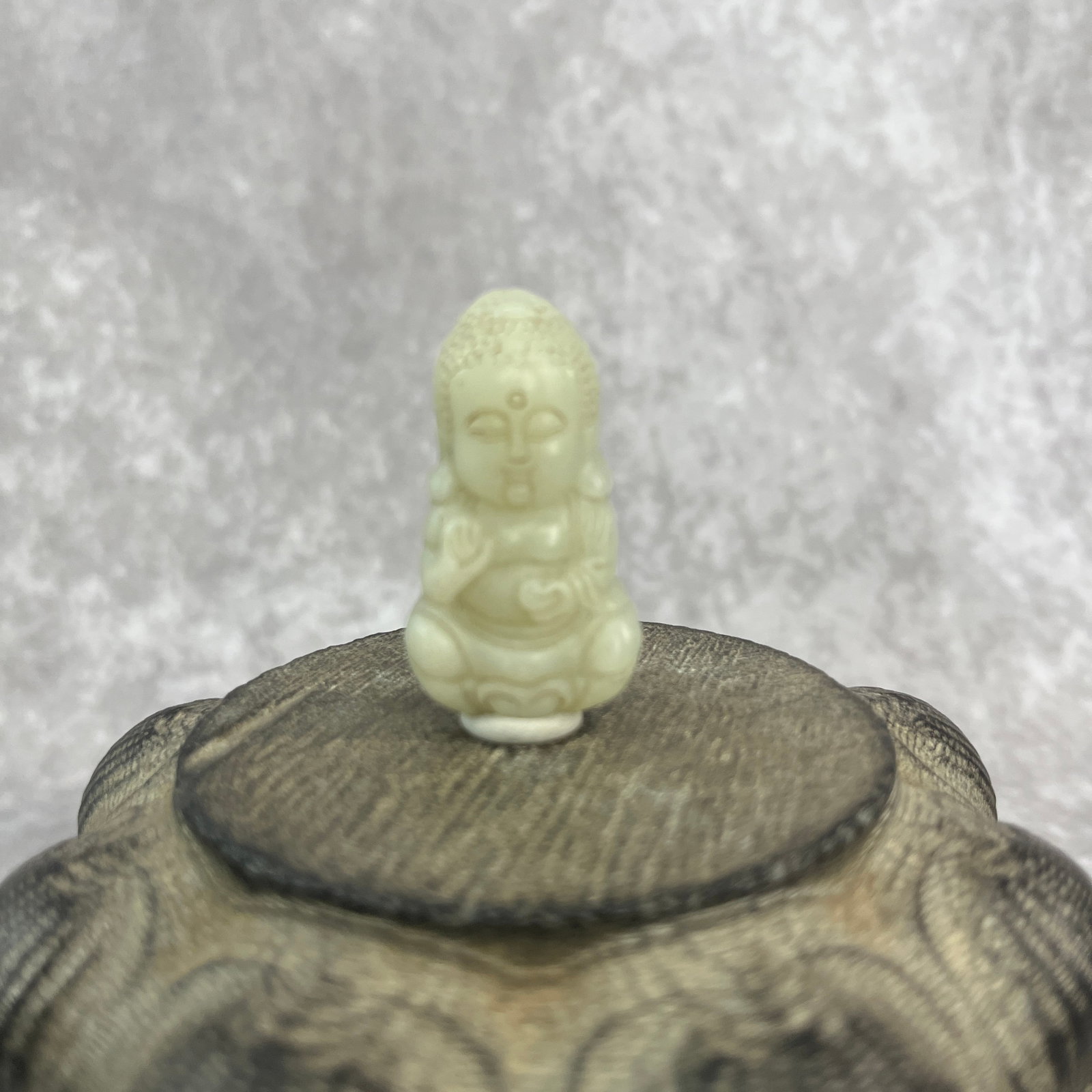 HAND-CARVED JADE FIGURINE OF A SEATED BUDDHA: Qing Dynasty; Long: 1.71 inch; Width: 0.97 inch; High: 0.43 inch
