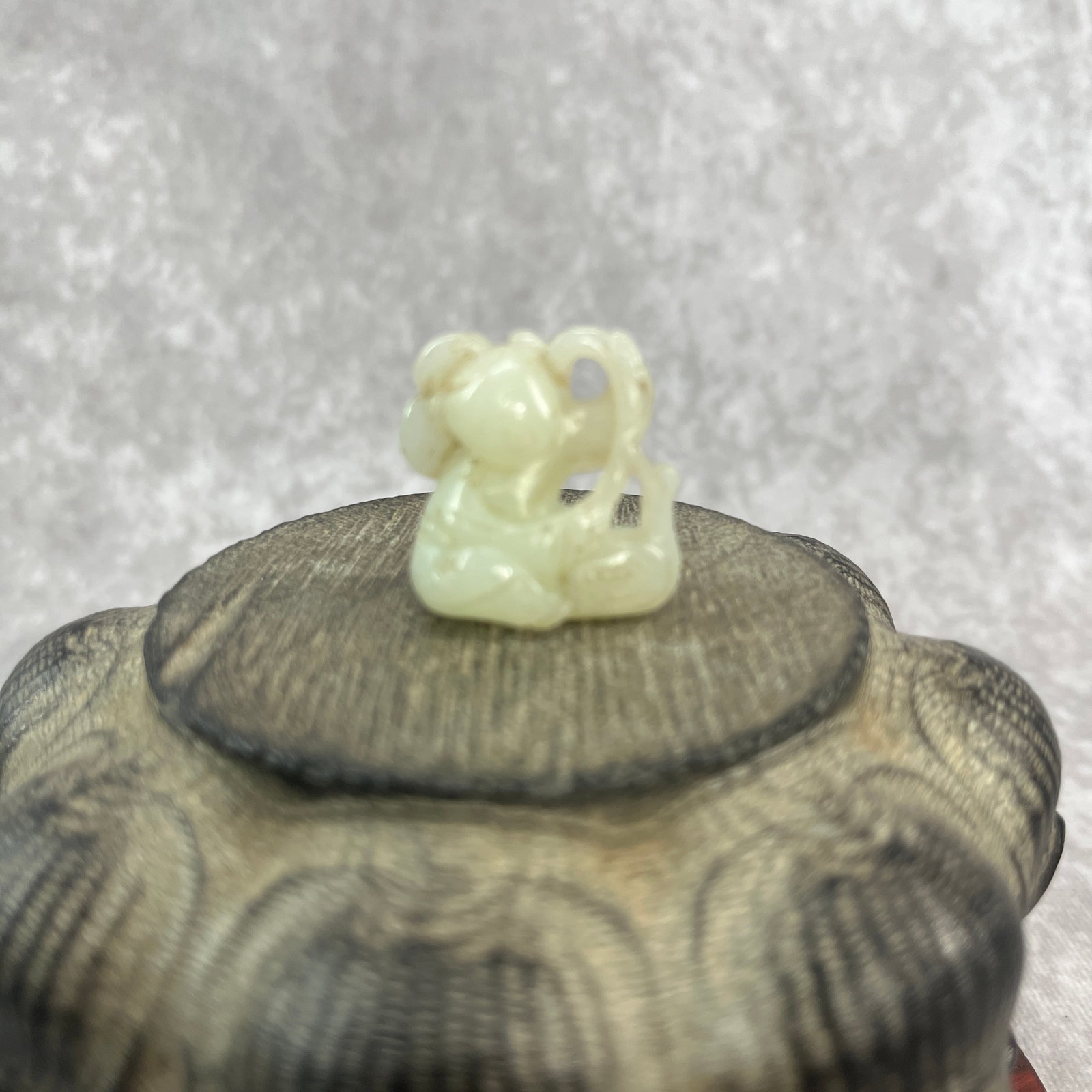 FINE HAND-CARVED JADE FIGURINE OF BOY: Qing Dynasty; Long: 1.1 inch; Width: 1.09 inch; High: 0.58 inch