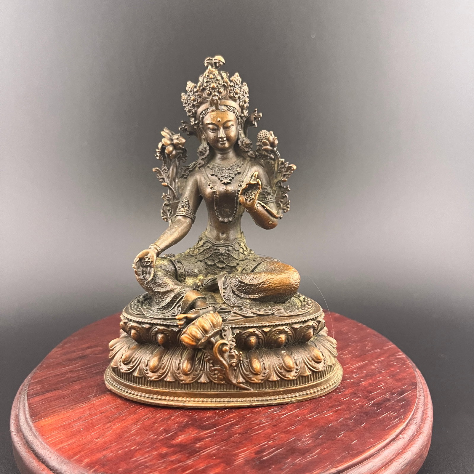 SMALL BRONZE SEATED FIGURE OF GREEN TARA: Qing Dynasty; Long: 3 inch; Width: 2.13 inch; High: 3.88 inch; Wooden base for diplay only