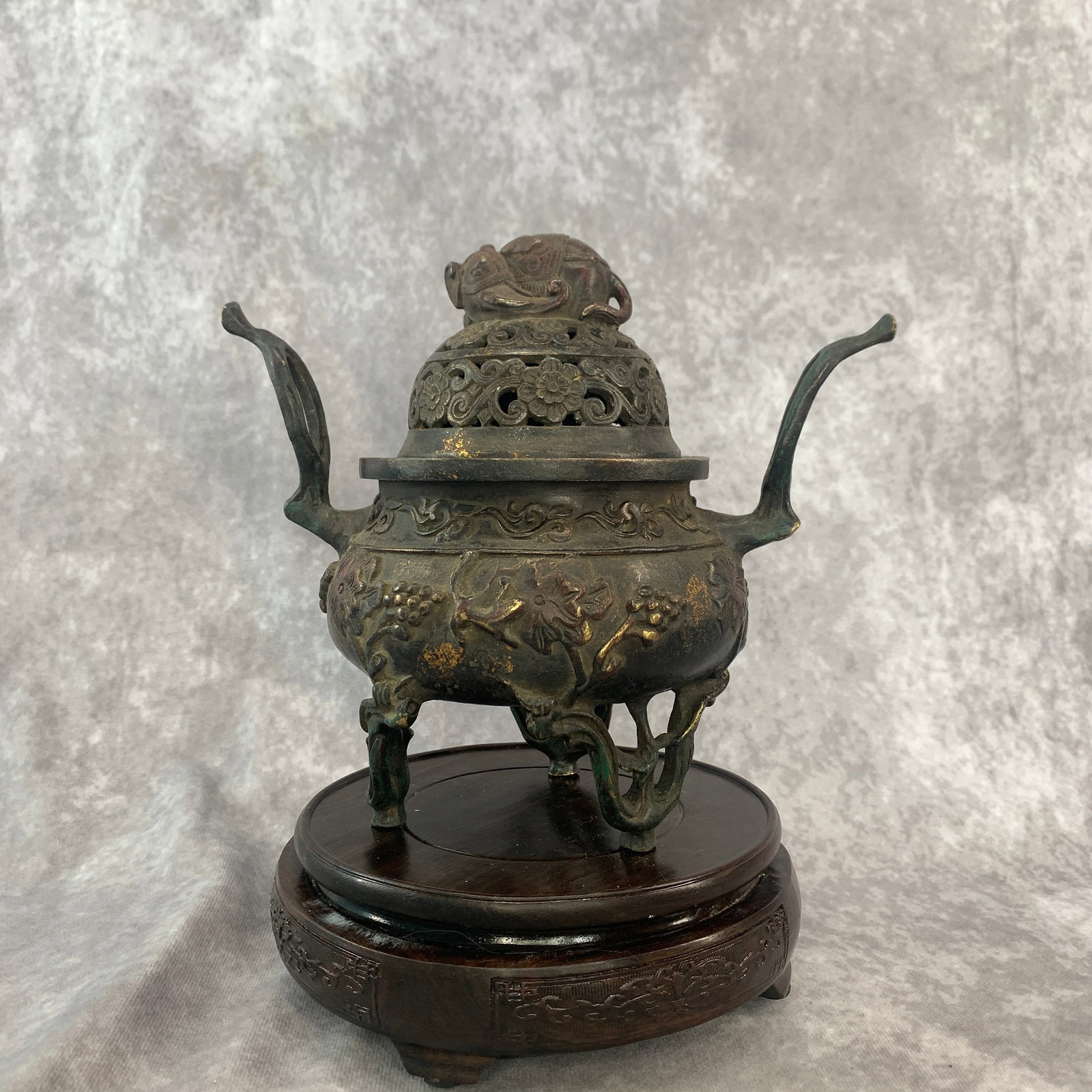 A GILT BRONZE TRIPOD CENSER WITH UPTURNED HANDLES ELEPHANT MOTIFS