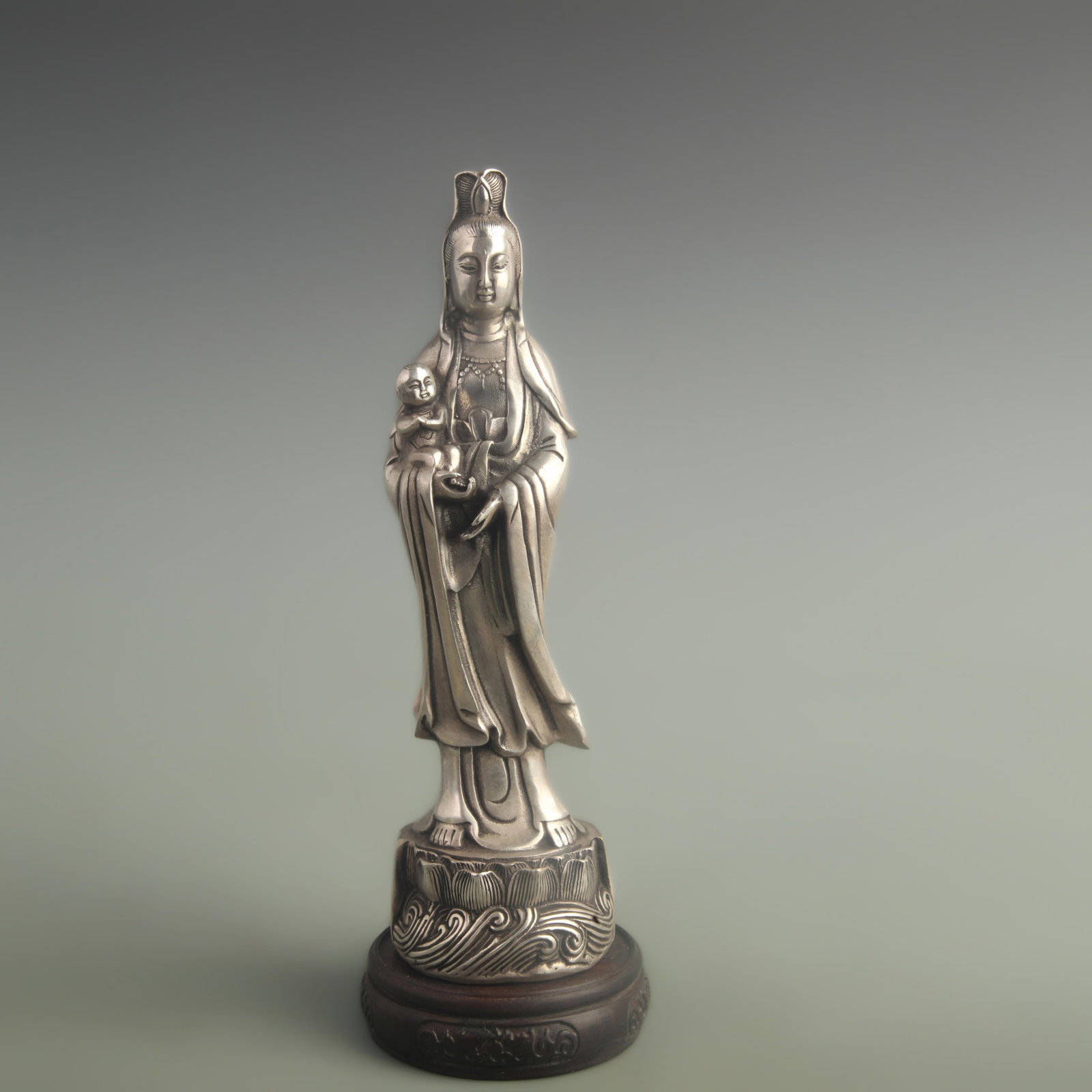 SILVER-GILT BRONZE GUANYIN WITH CHILD FIGURE: Qing Dynasty Qian Long Period; High:10.0 inch; Diameter: 2.80 inch; Wooden base for diplay only