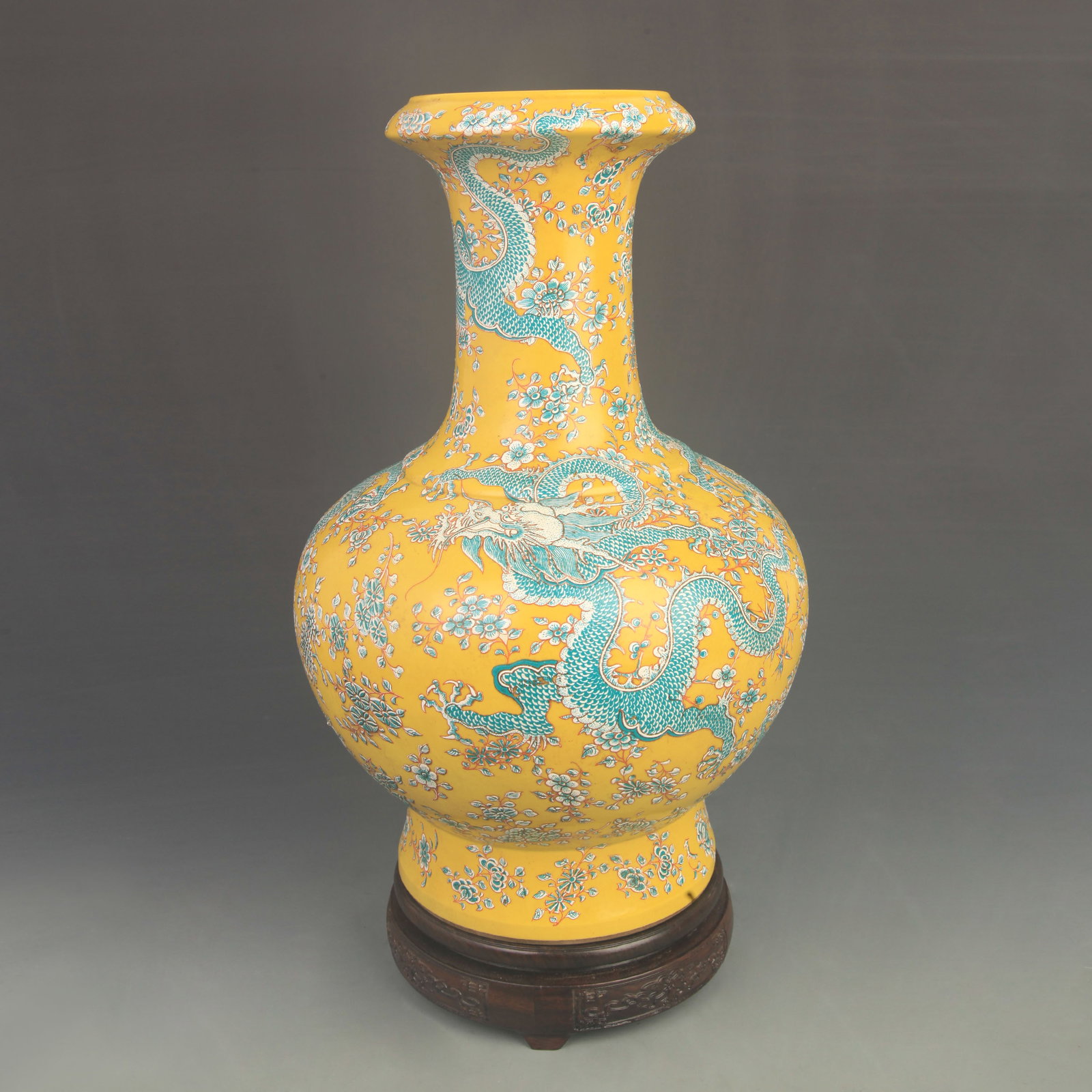 FAMILLE ROSE YELLOW GROUND DRAGON PATTERN MOUTH PORCELAIN VASE: Qing Dynasty Kang Xi Period; High: 14.5 inch; Diameter: 8.20 inch; Wooden base for diplay only